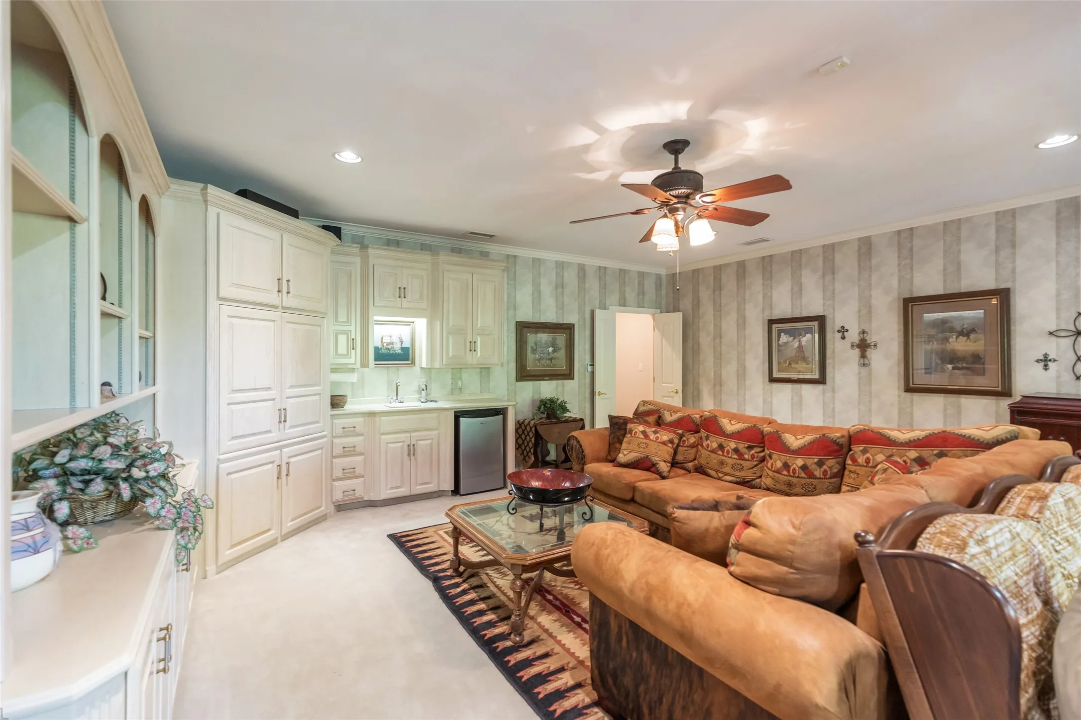Upstairs living room with wrap around custom cabinets and wet bar.