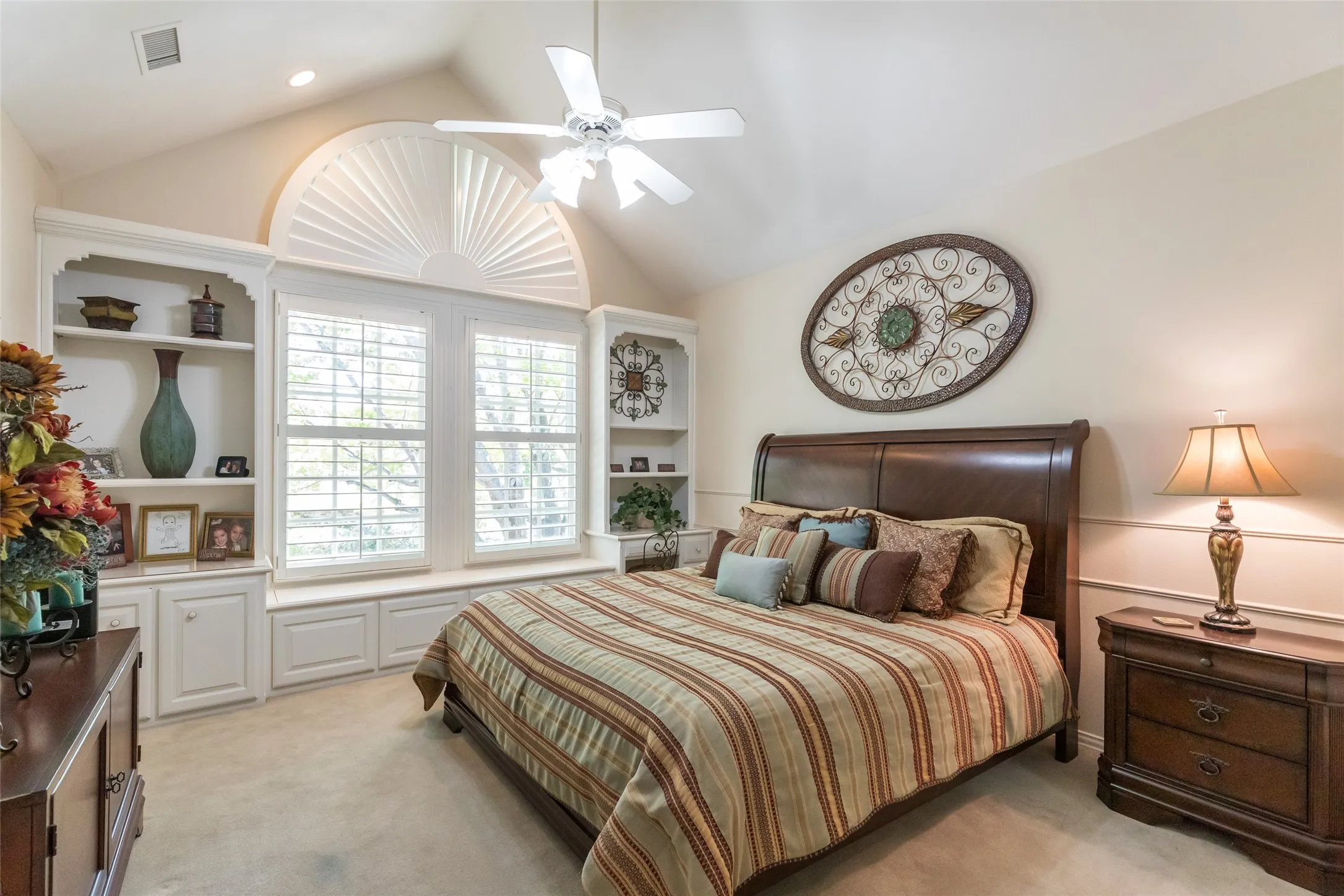 Upstairs bedroom with built in desk, plantation shutters and window seat.  Vaulted ceilings and private en suite bath.