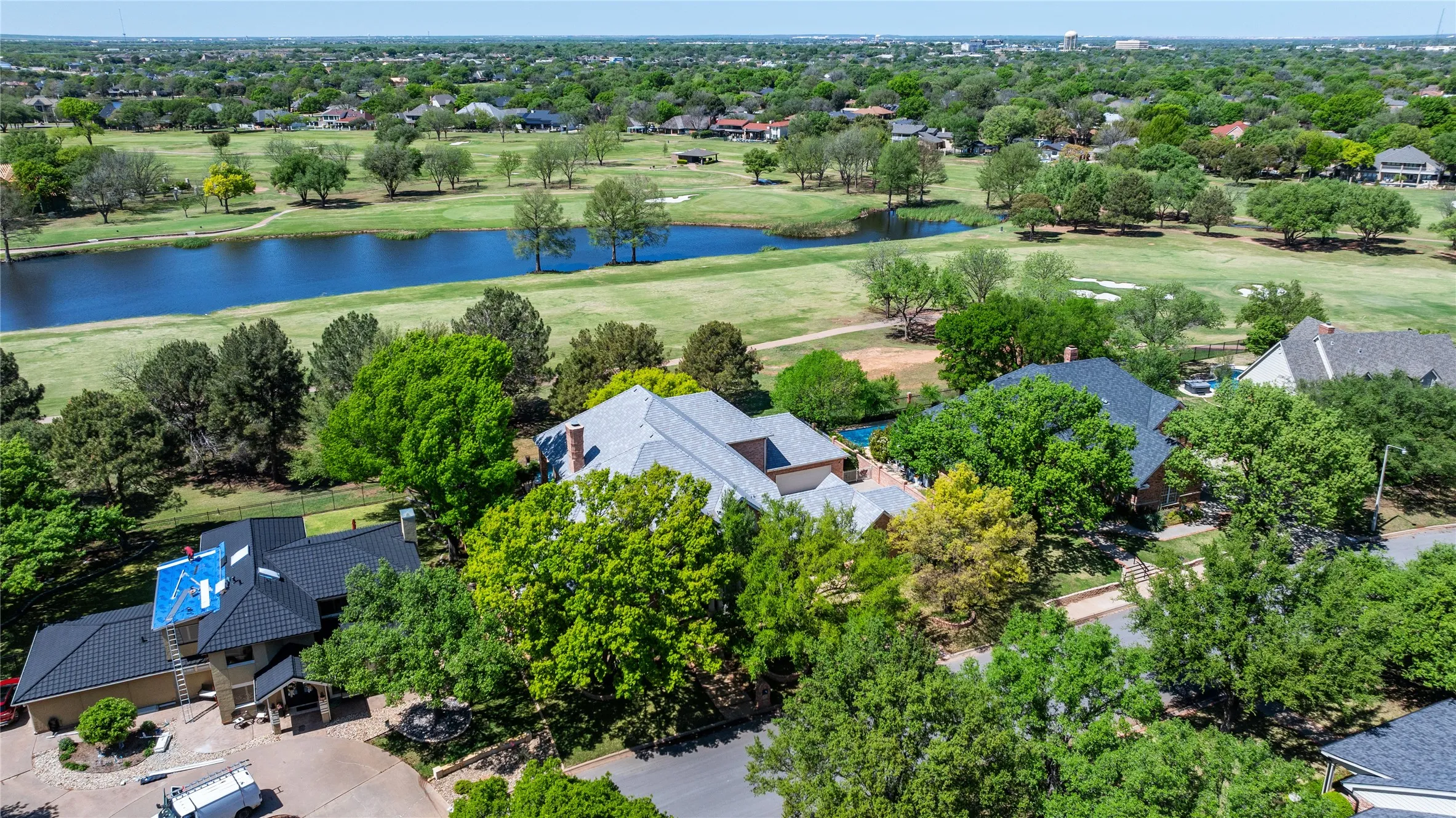 Gorgeous aerial view of golf course and pond!  Mature trees and Class 4 roof.