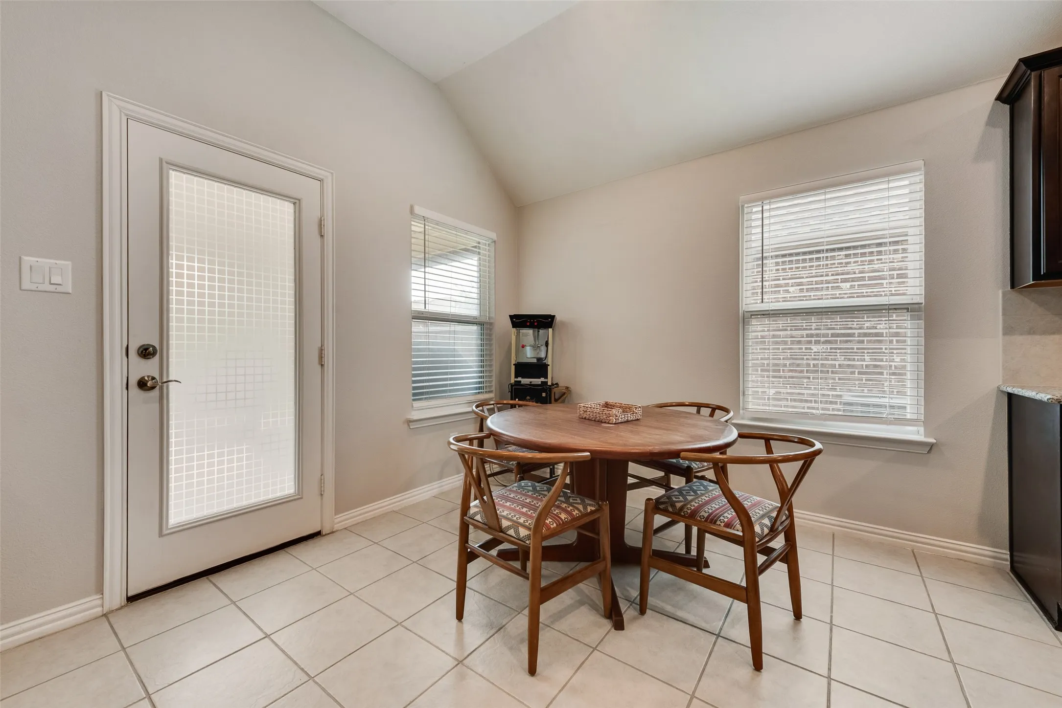 Dining area off of kitchen with ceramic tile floors and door to back yard at 1432 Westview Ln in the Canyon Falls community in Northlake, TX