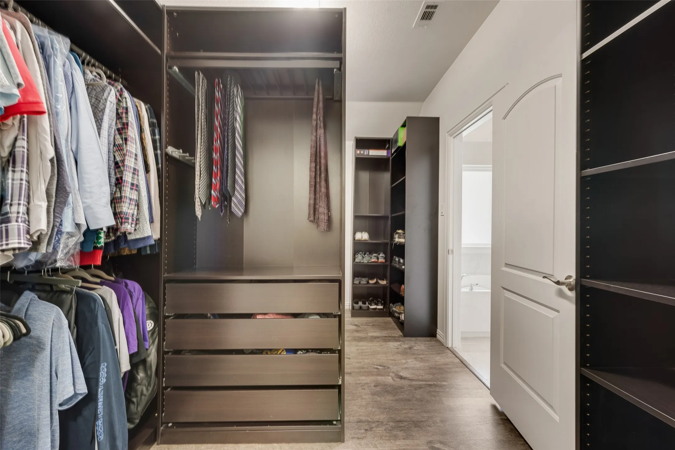 Easy closet organization with this custom built modular system at 1432 Westview Ln in the Canyon Falls community in Northlake, TX