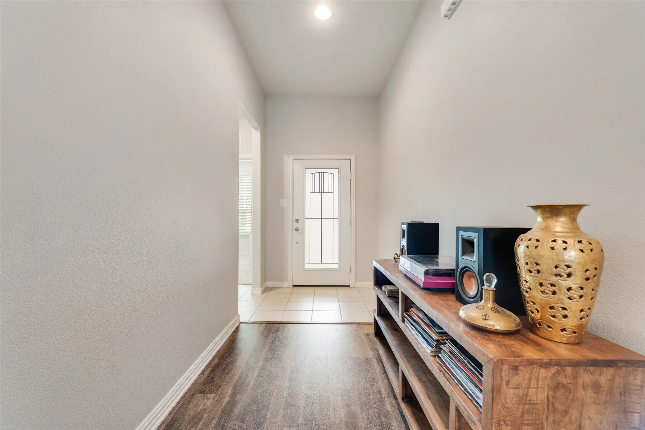 Brand new LVP floors in entry with hallway leading to two bedrooms and bathroom on the left at 1432 Westview Ln in the Canyon Falls community in Northlake, TX