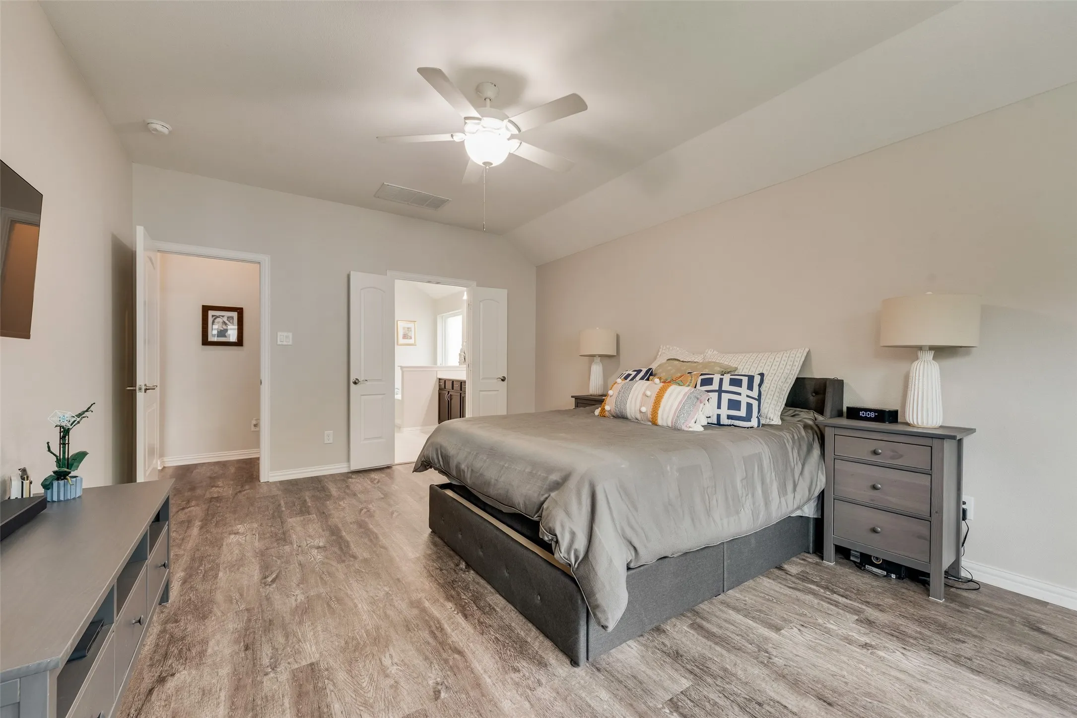 Primary bedroom with new LVP flooring, ensuite bathroom and abundant natural light at 1432 Westview Ln in the Canyon Falls community in Northlake, TX