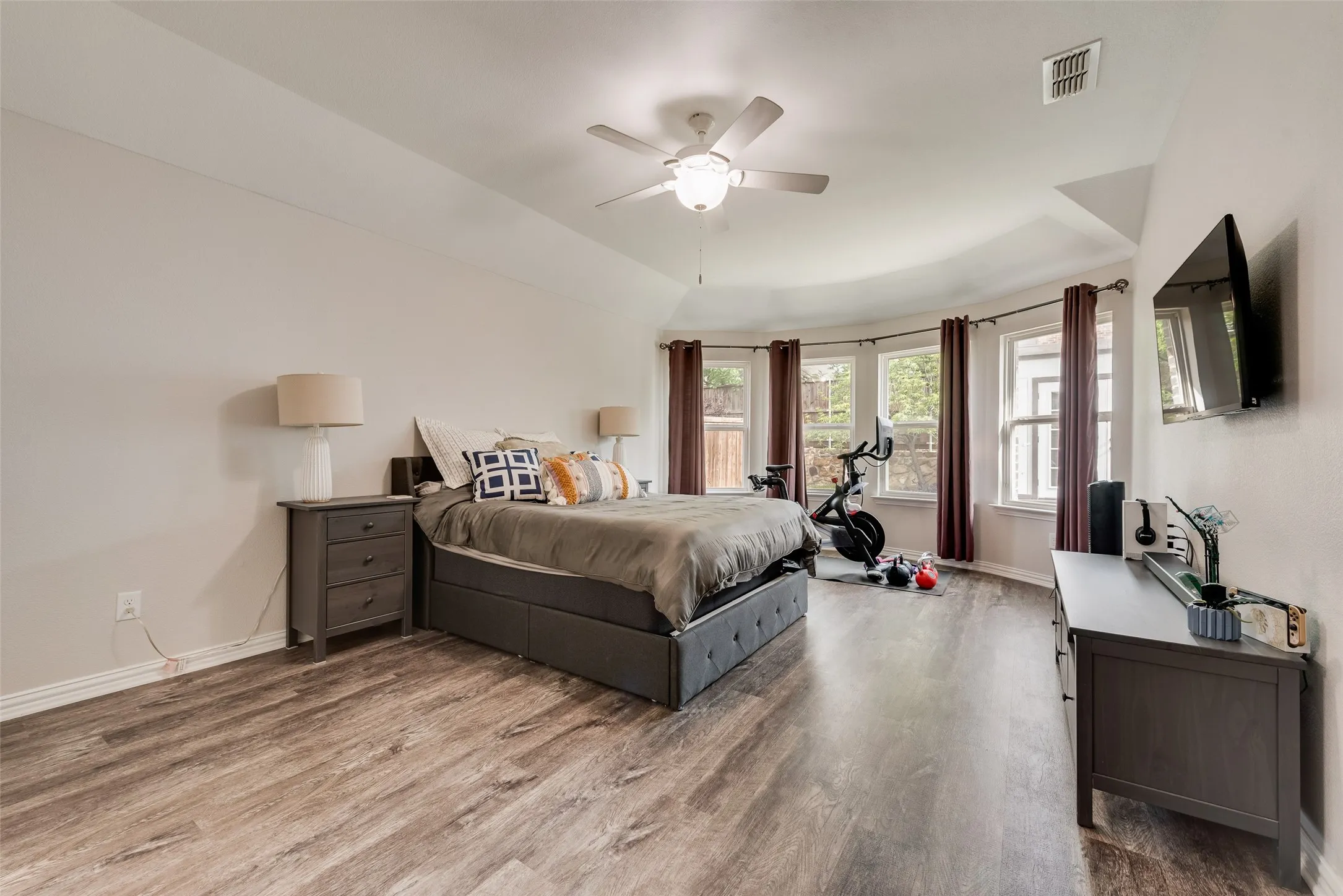Primary bedroom with new LVP flooring, ensuite bathroom and abundant natural light at 1432 Westview Ln in the Canyon Falls community in Northlake, TX