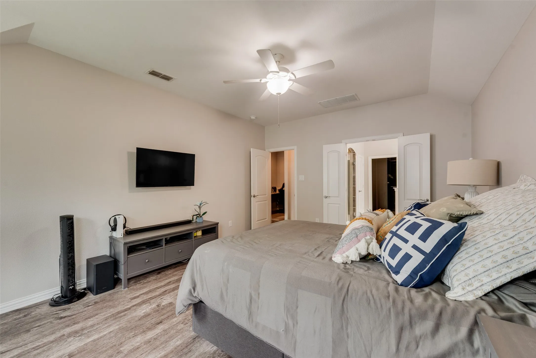 Primary bedroom with new LVP flooring, ensuite bathroom and abundant natural light at 1432 Westview Ln in the Canyon Falls community in Northlake, TX