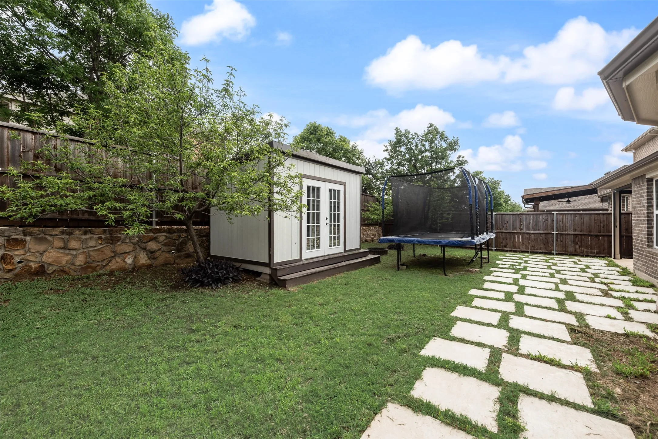 Backyard with concrete pavers and storage shed at 1432 Westview Ln in the Canyon Falls community in Northlake, TX