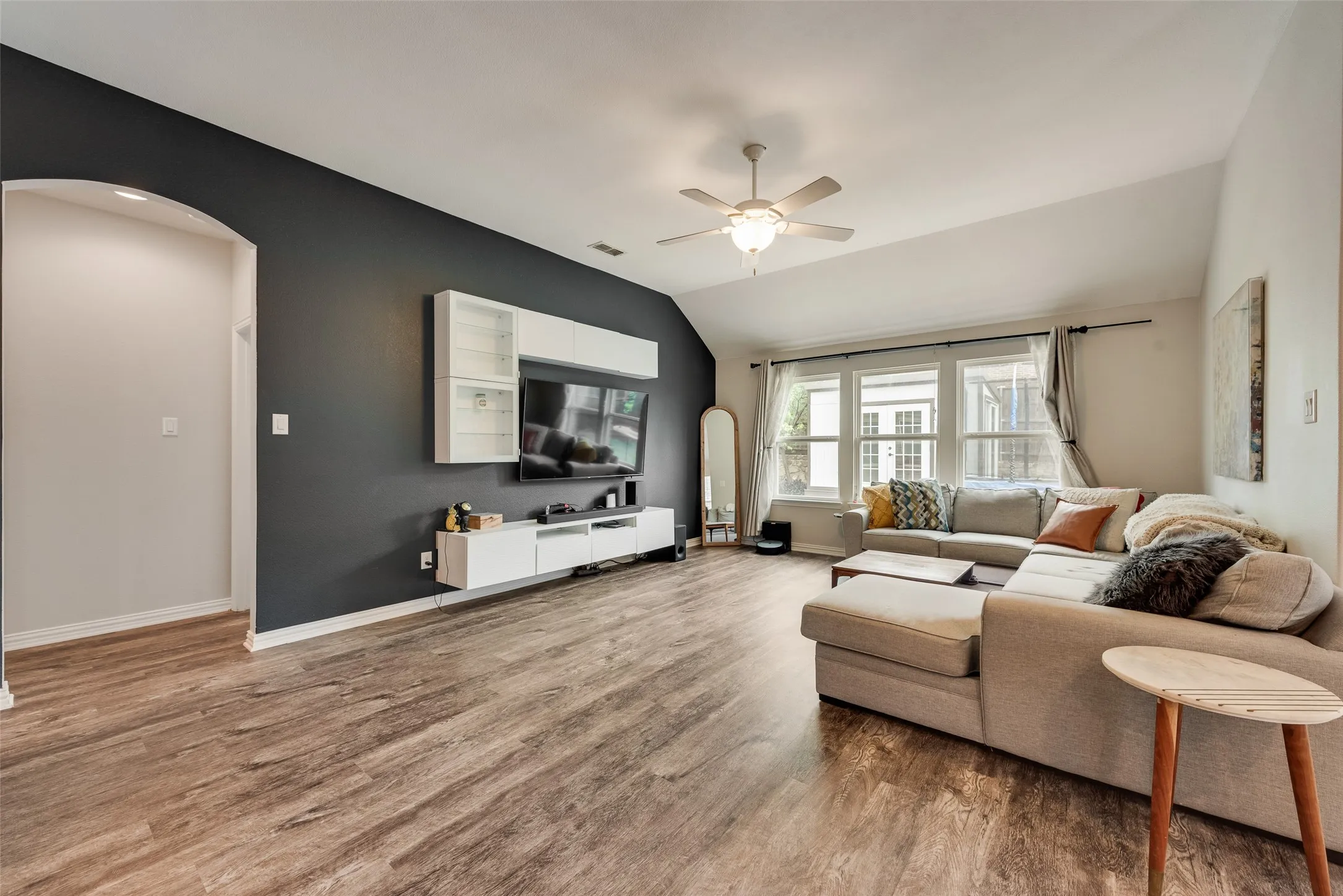 Spacious living room with new LVP flooring and natural light from the large windows at 1432 Westview Ln in the Canyon Falls community in Northlake, TX