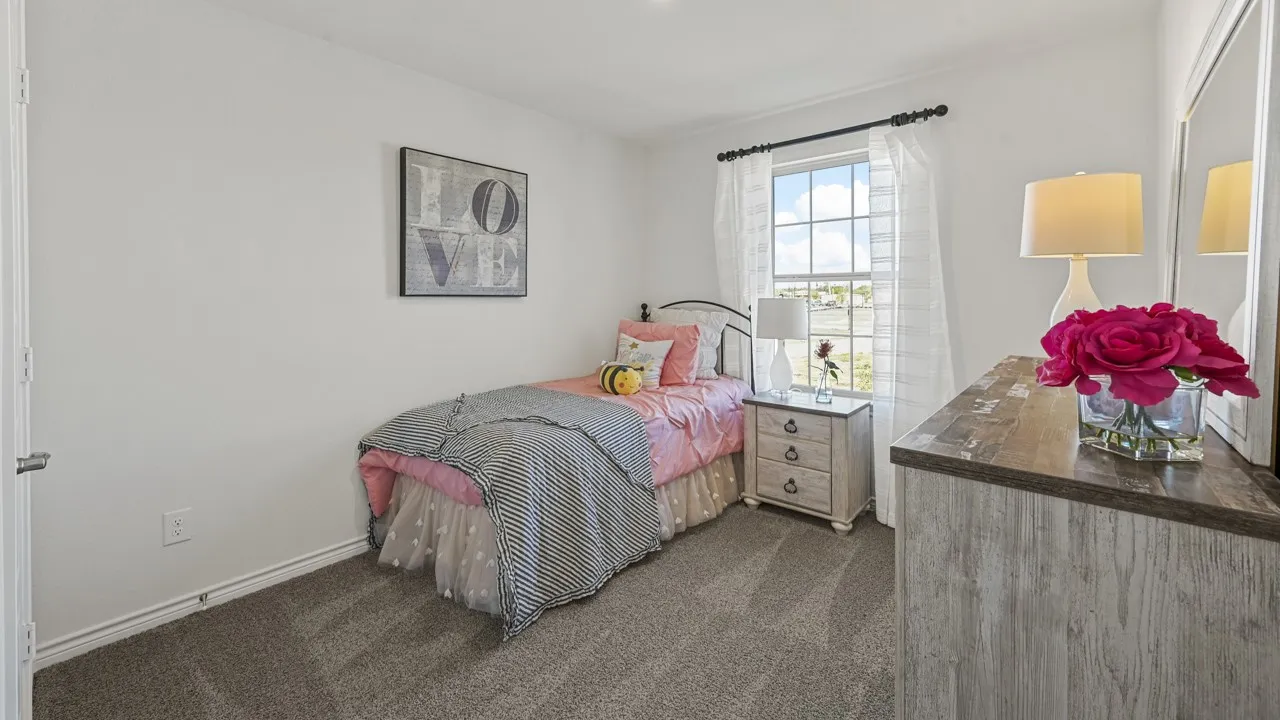 Carpeted room featuring a double-paned window, white baseboards, and a white interior door