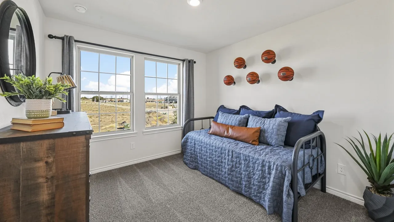 Bright room featuring two large windows with grid patterns, offering expansive outdoor scenery