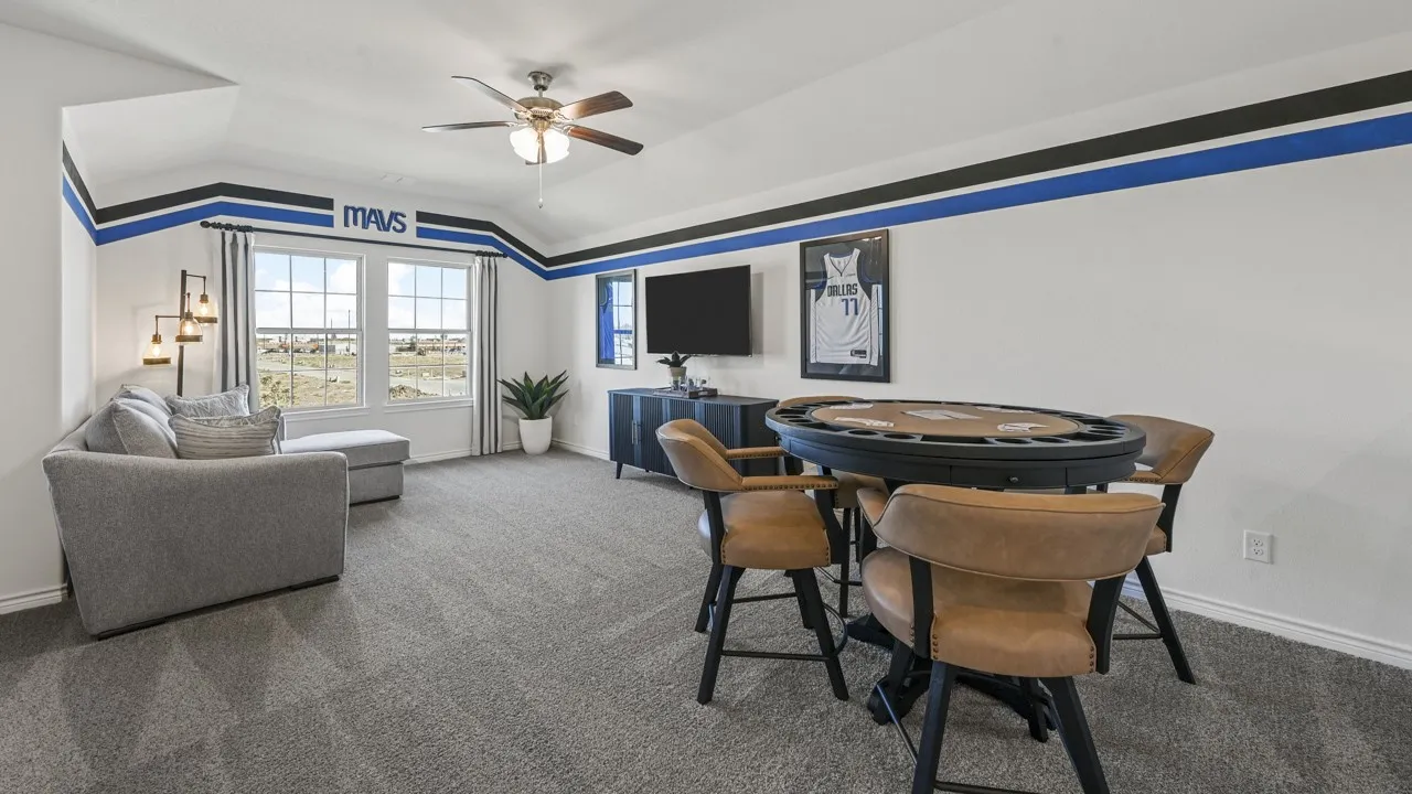 Spacious bonus room featuring vaulted ceilings, a ceiling fan, and carpet flooring