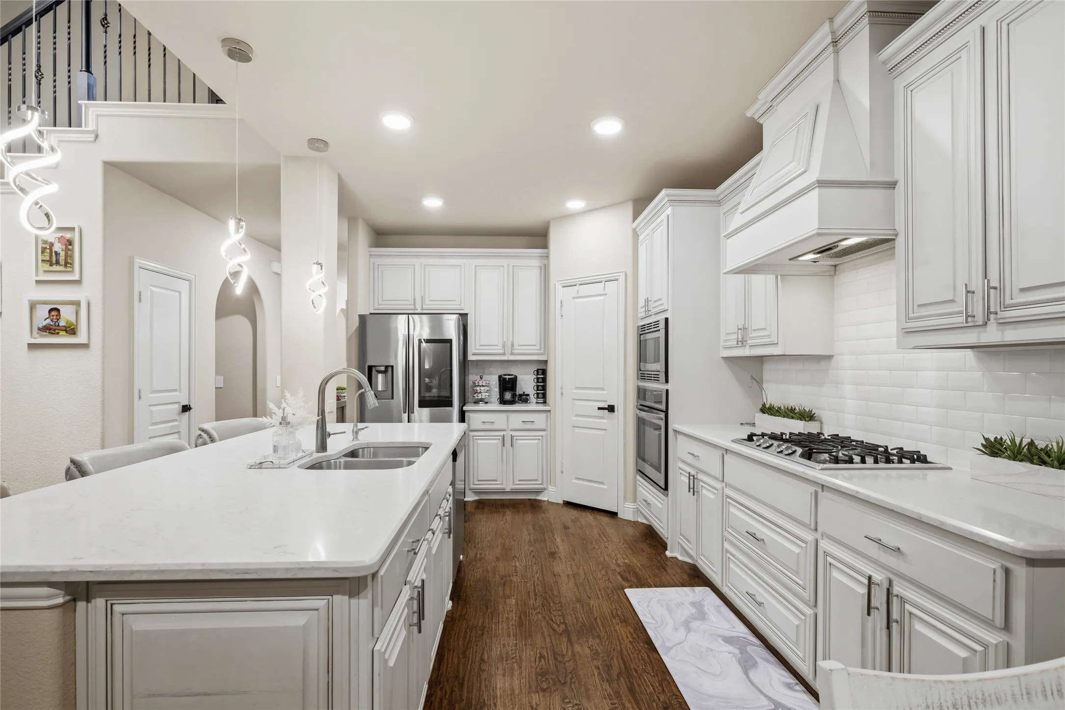 The home has a large kitchen with a wall oven and microwave, gas cooktop and granite countertops.