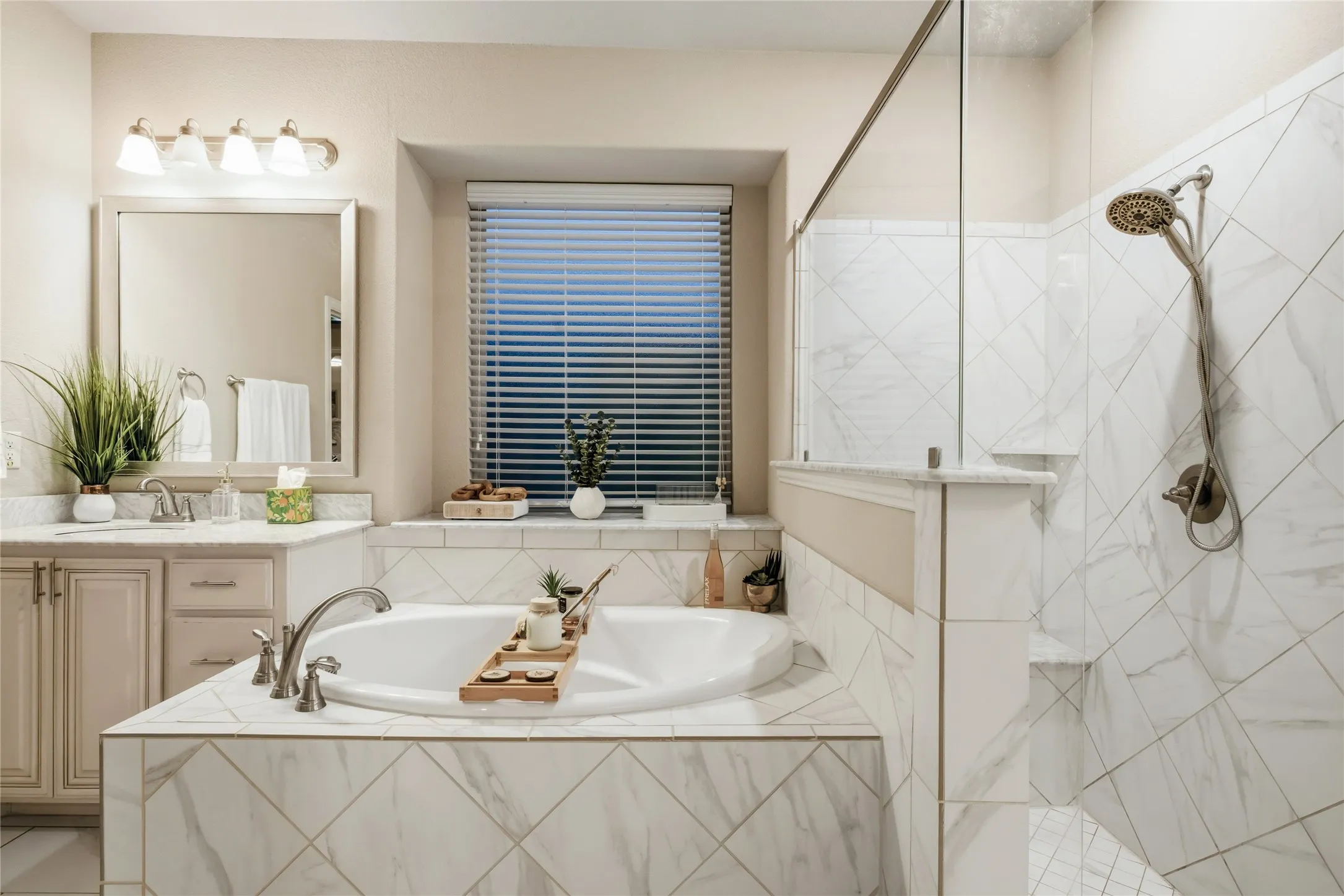View of garden tub, frosted window, and shower.