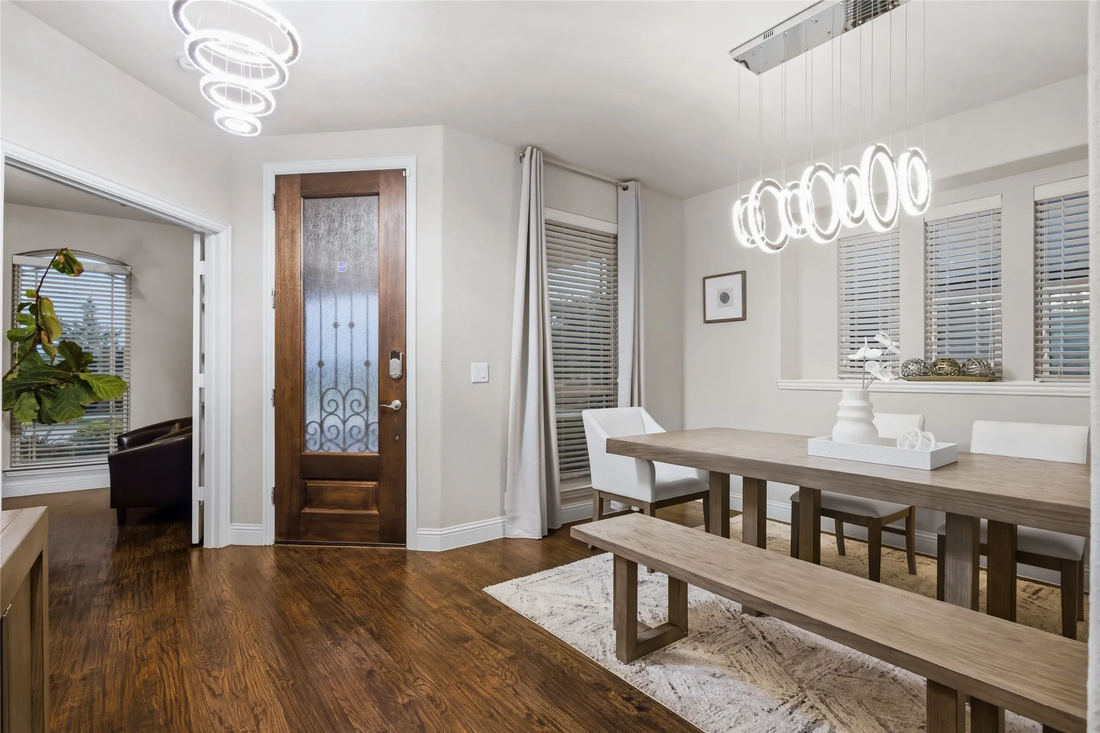 The foyer is bright and open and next to the dining area and office.