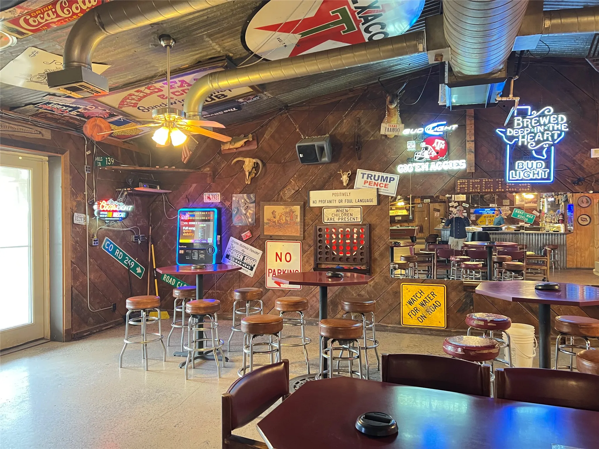 Interior space featuring a corrugated metal ceiling and wood paneling