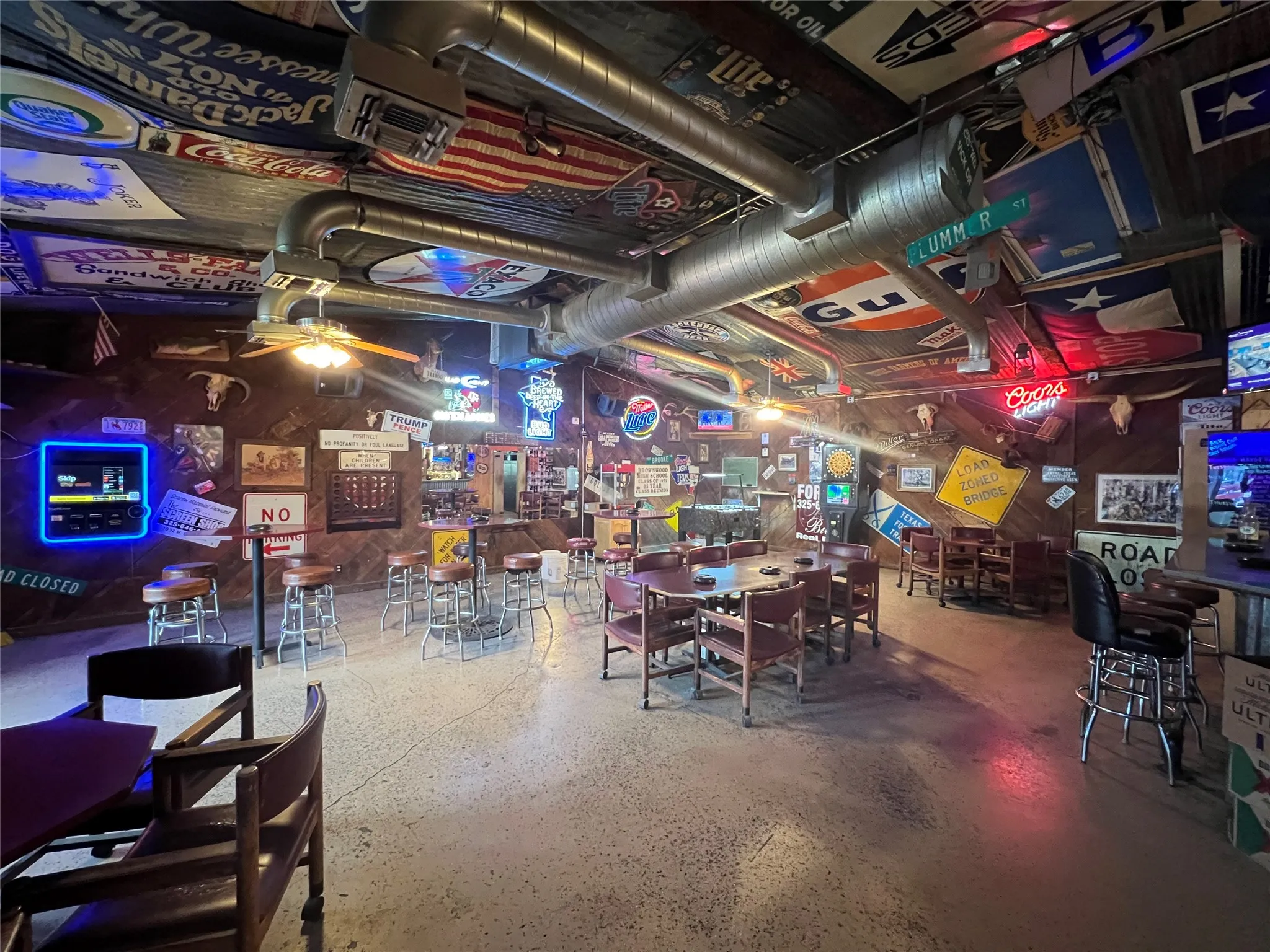 Expansive interior space featuring concrete flooring and exposed ductwork