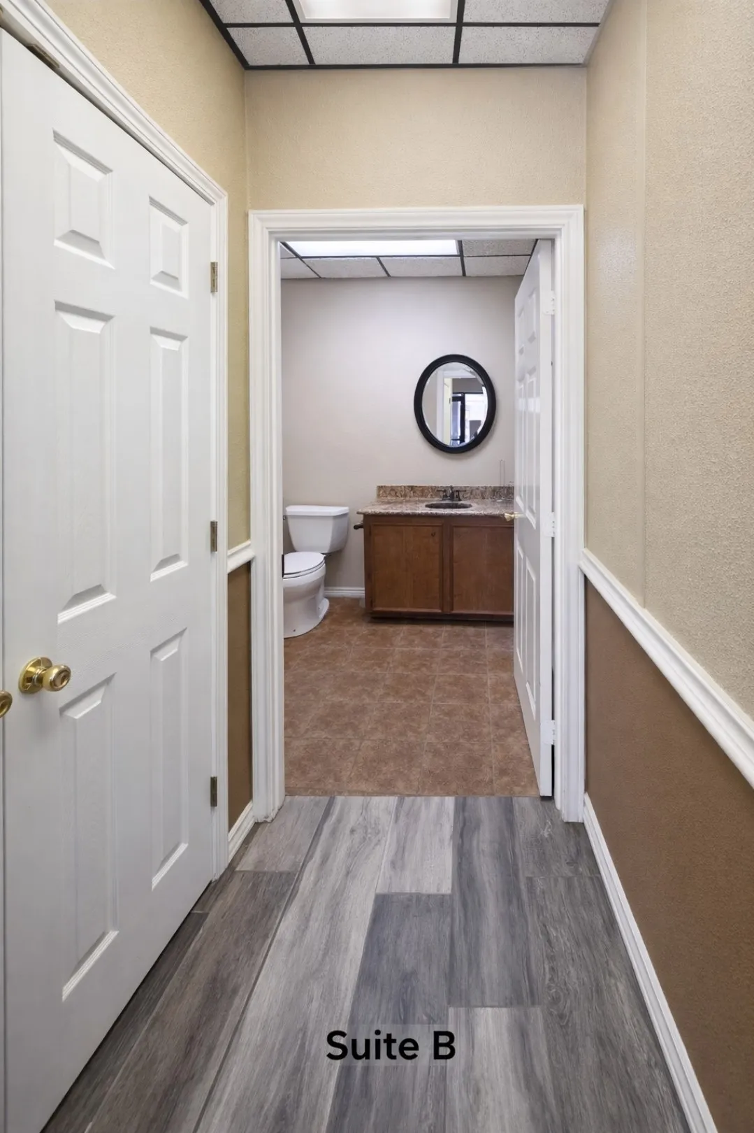 Suite B entry hall featuring wood-finish flooring and two-tone wall treatment
