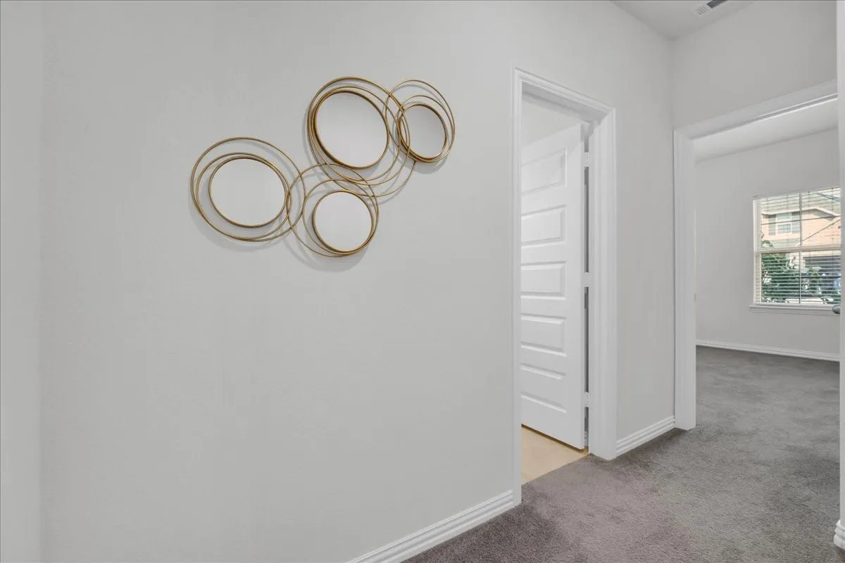 hall leading to secondary bedrooms and bath