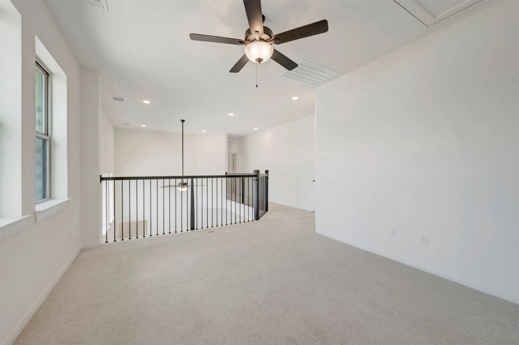 Carpeted loft area with recessed lighting, a ceiling fan, and painted white walls