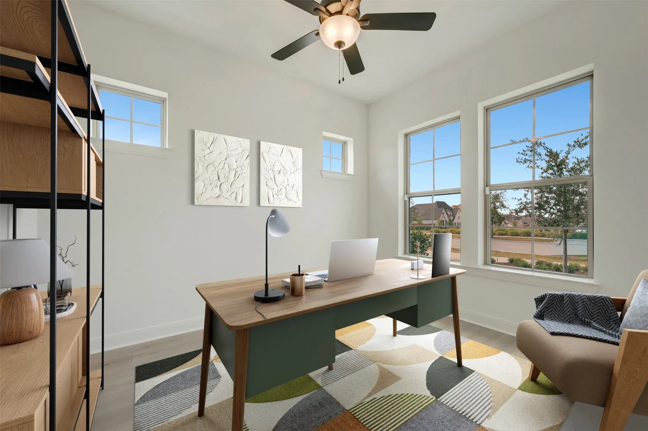 Interior room featuring light neutral wall paint, wood-finish flooring, and multiple windows