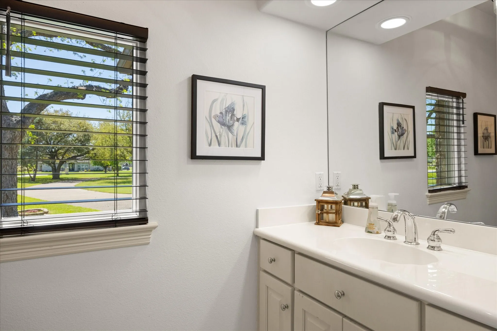 Bathroom vanity featuring a light-colored countertop, undermount sink, and chrome fixtures