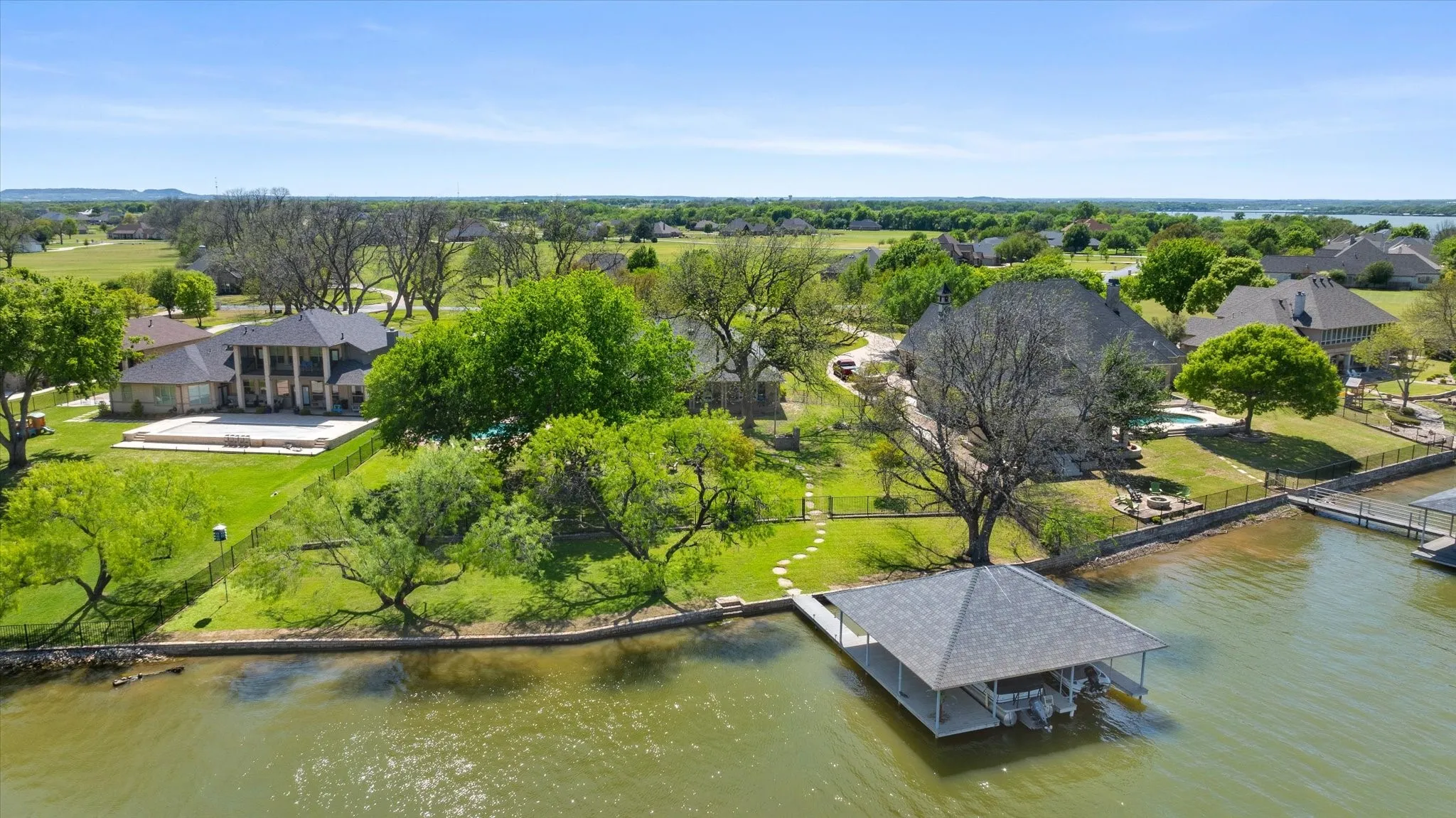 Waterfront property featuring a private boat dock with covered slips