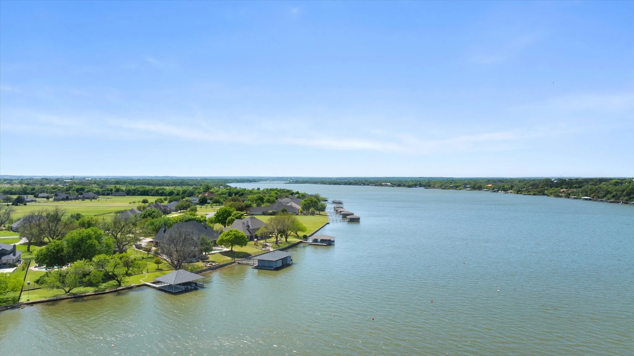 Expansive waterfront properties featuring private boat docks and covered slips