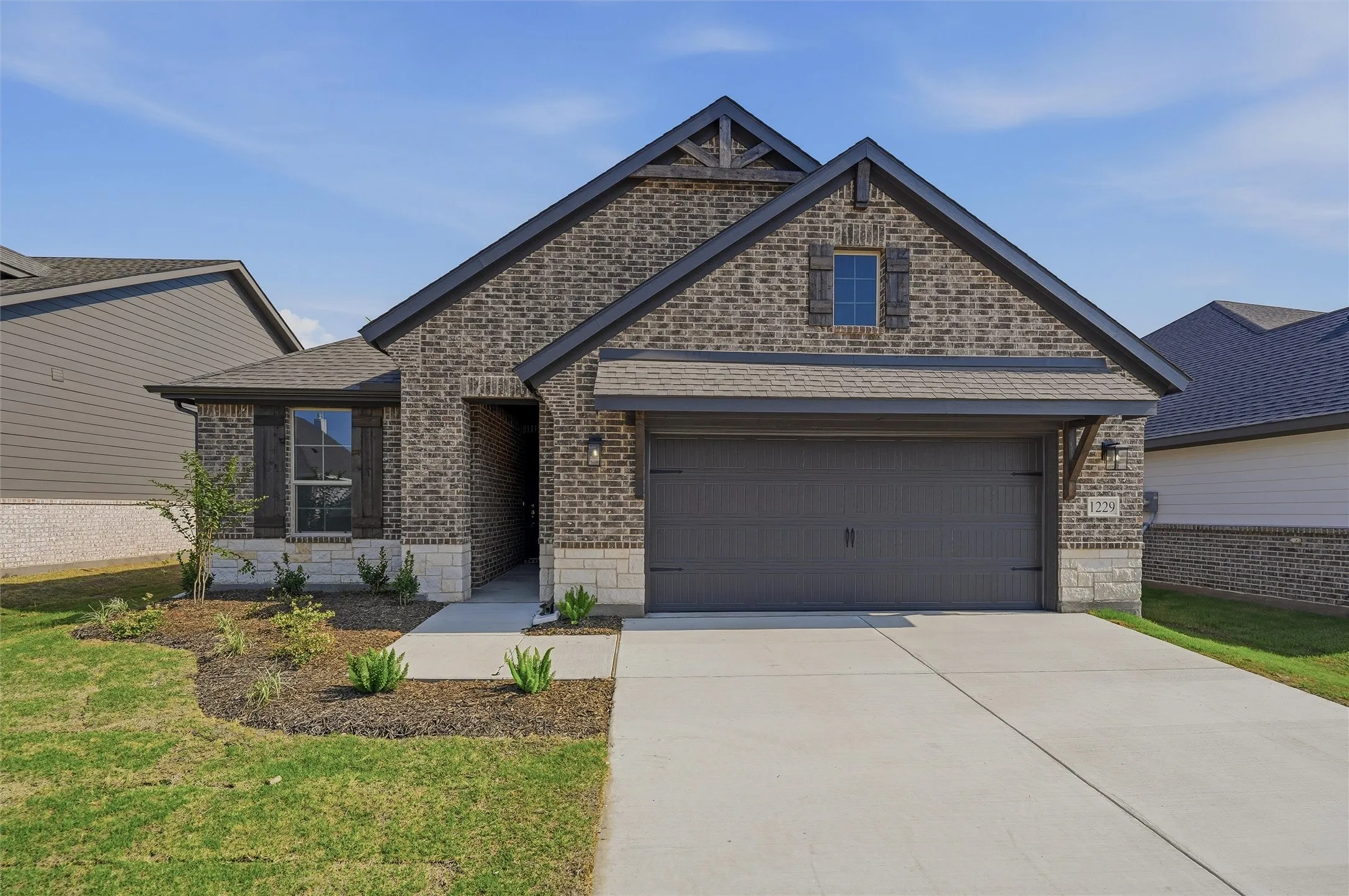 Brick exterior with architectural gable detailing and transom window accents
