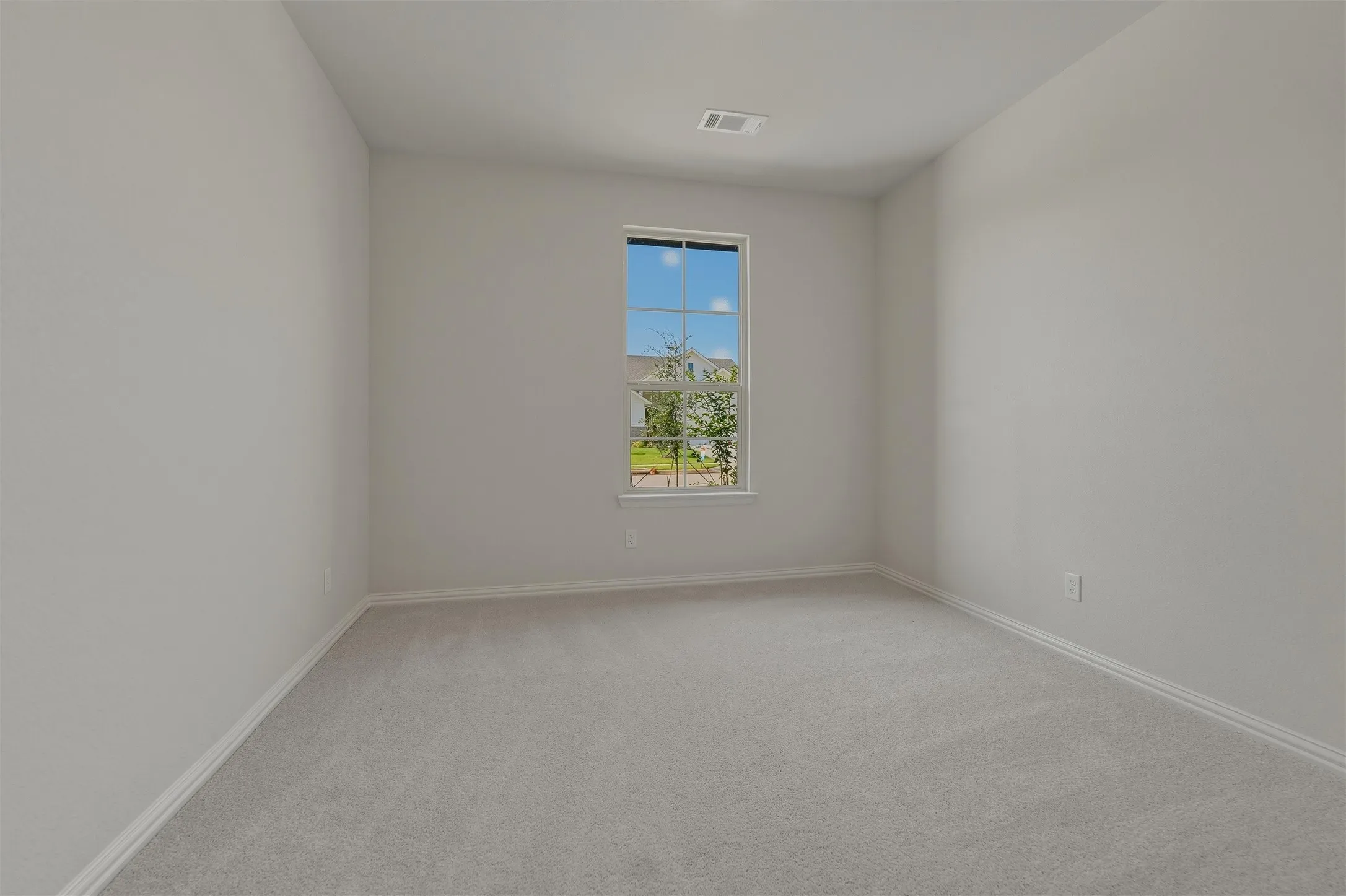 Neutral-toned walls complement plush carpeting