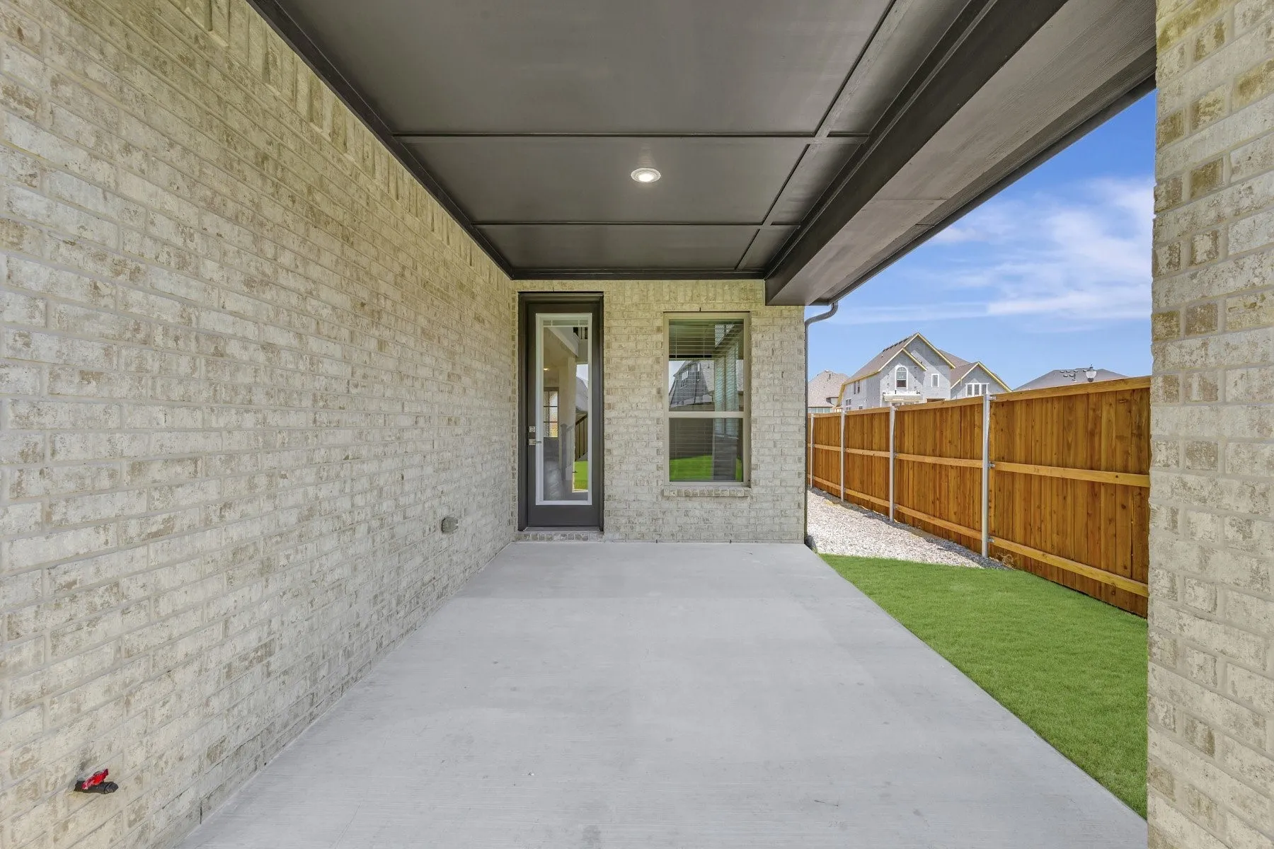 Covered concrete patio featuring recessed lighting, a full-lite exterior door, and a single window