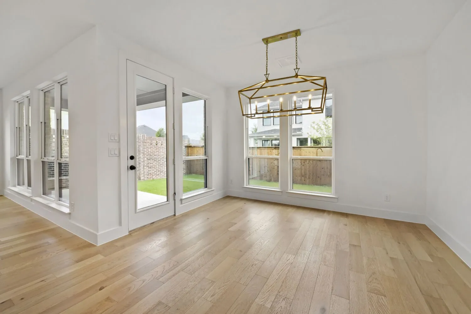 Light wood-finish flooring complements the white walls