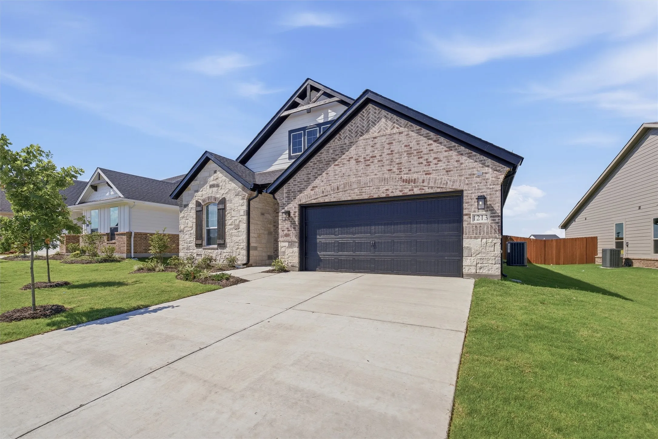 Stone and brick facade with a two-car garage