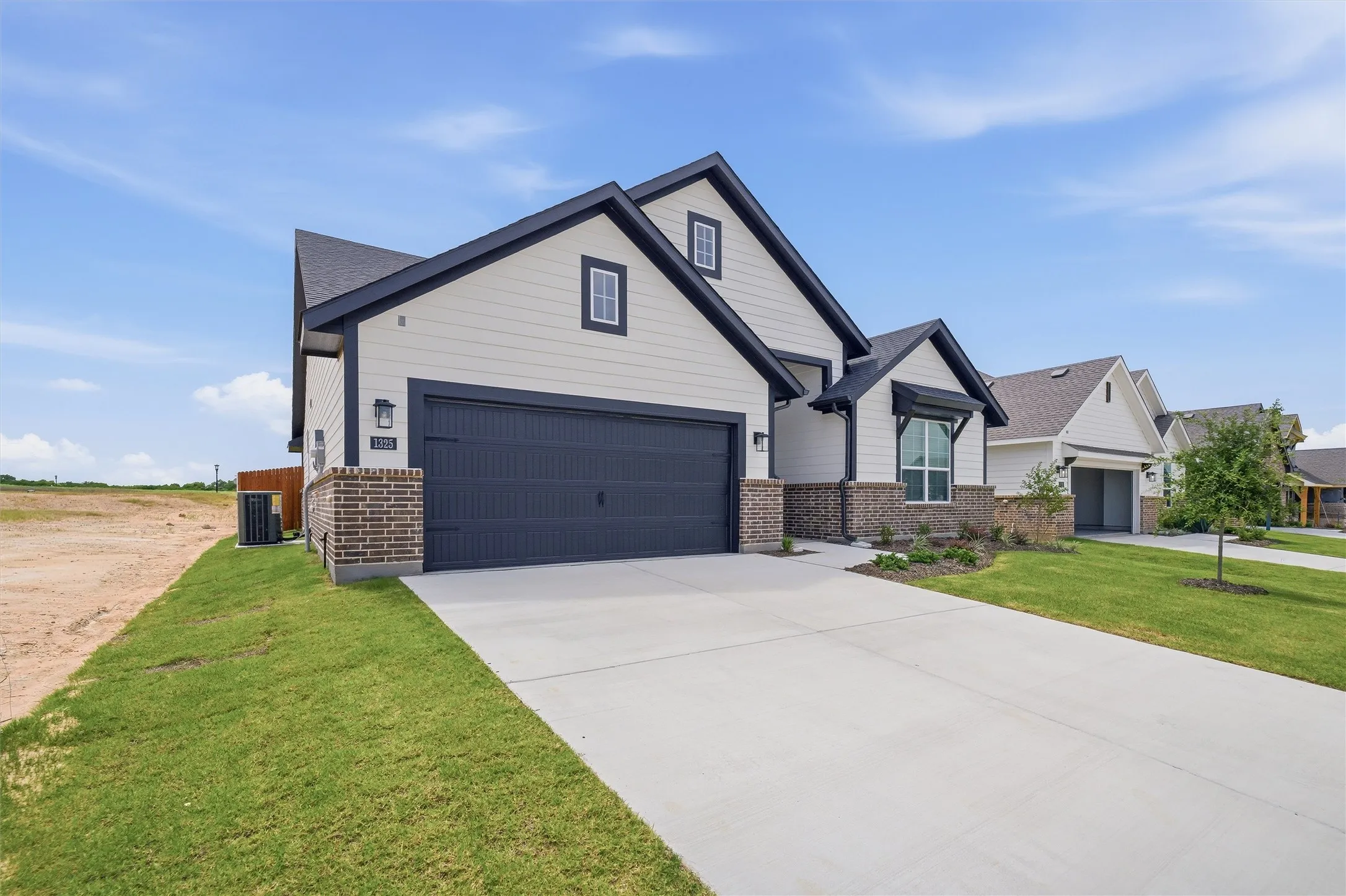 Contemporary exterior with white siding and dark trim