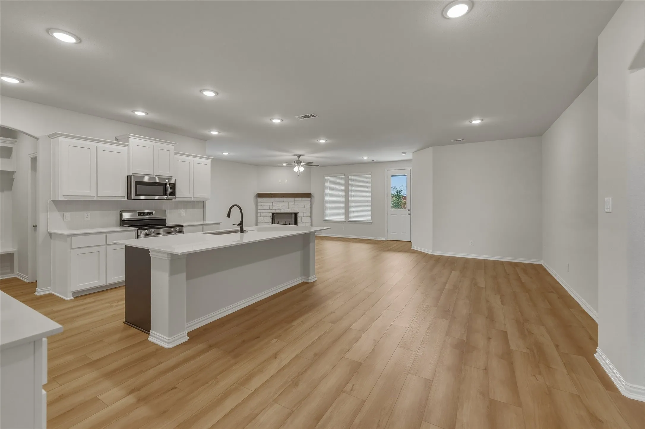 Open-concept interior featuring wood-finish flooring throughout