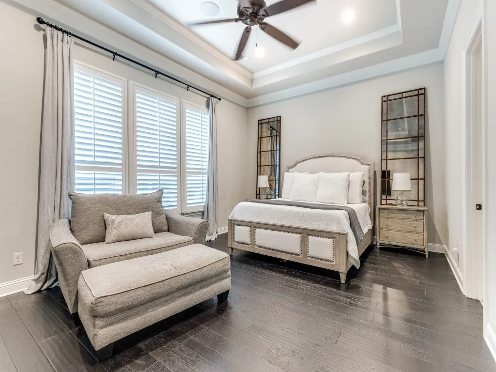 Spacious interior featuring dark wood-finish flooring and a tray ceiling with recessed lighting