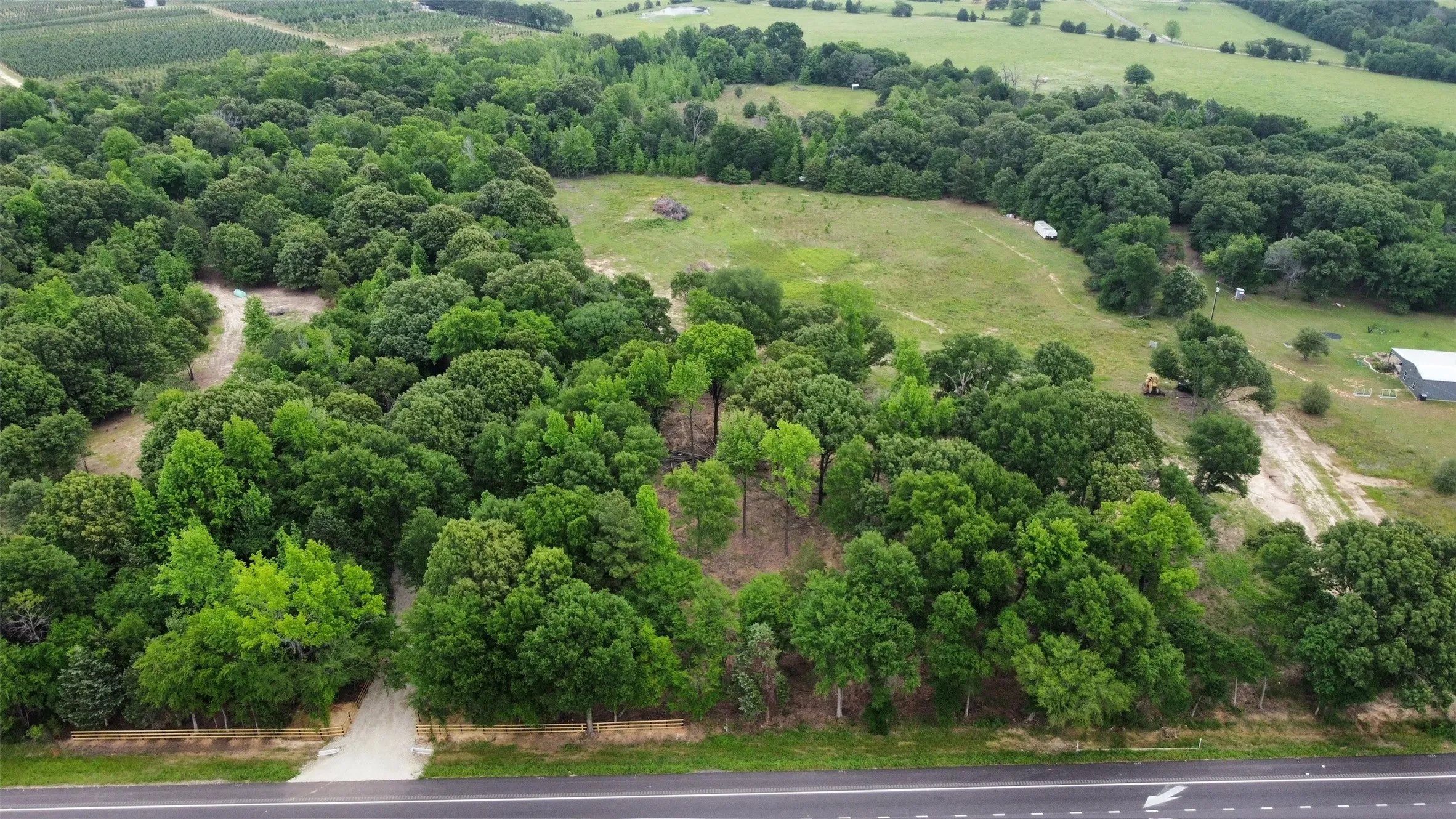 View from Hwy 19 facing east. Treeline buffer between Hwy and 1st pasture, 2nd pasture in far top center of photo.