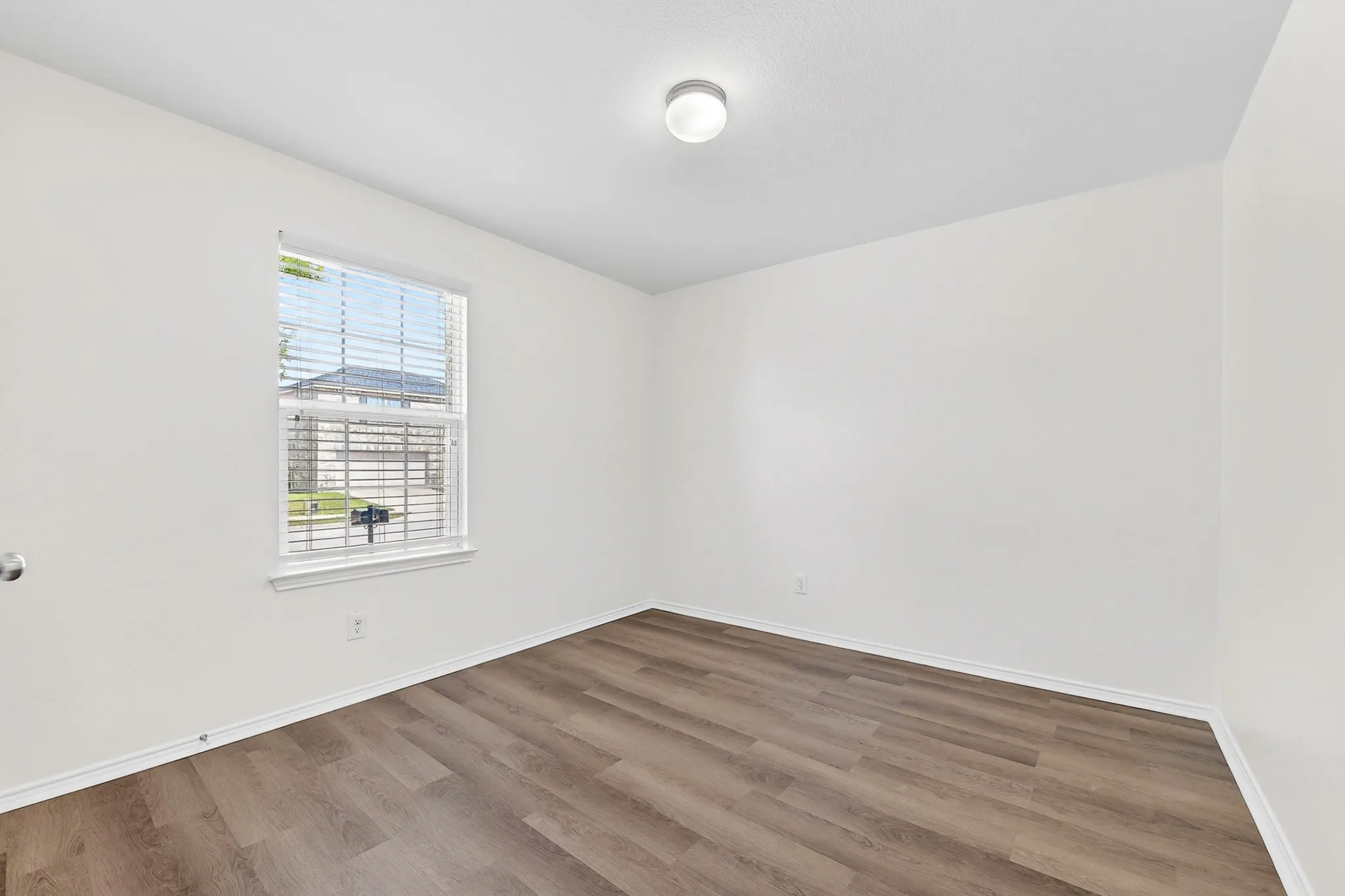 One of 2 secondary bedrooms with LVP flooring and freshly painted walls