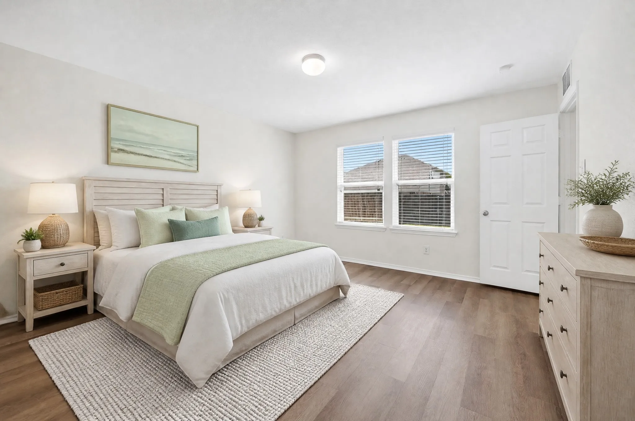 Virtually staged primary bedroom located in the rear of the home, separate from other bedrooms