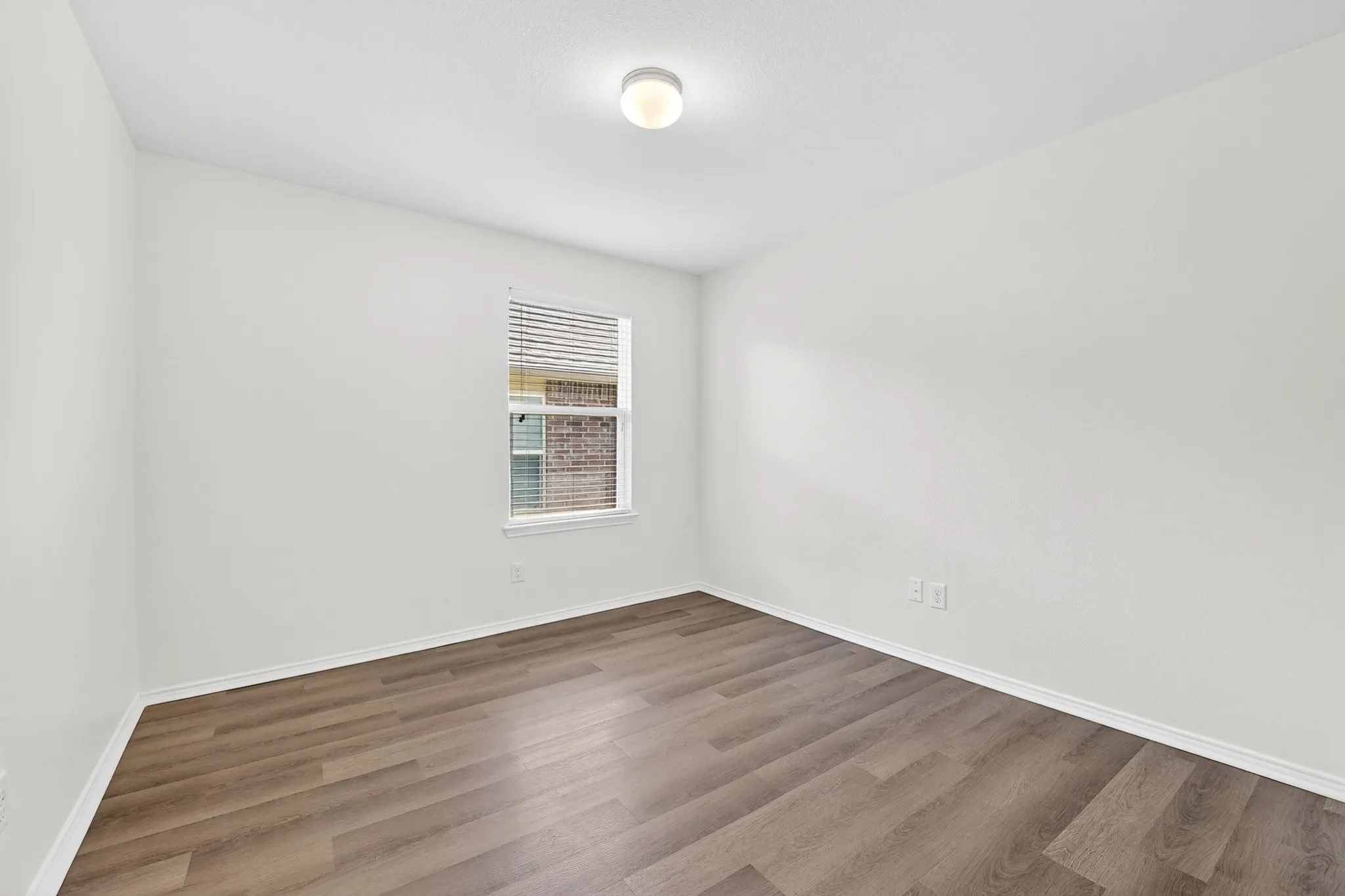 One of 2 secondary bedrooms with LVP flooring and freshly painted walls