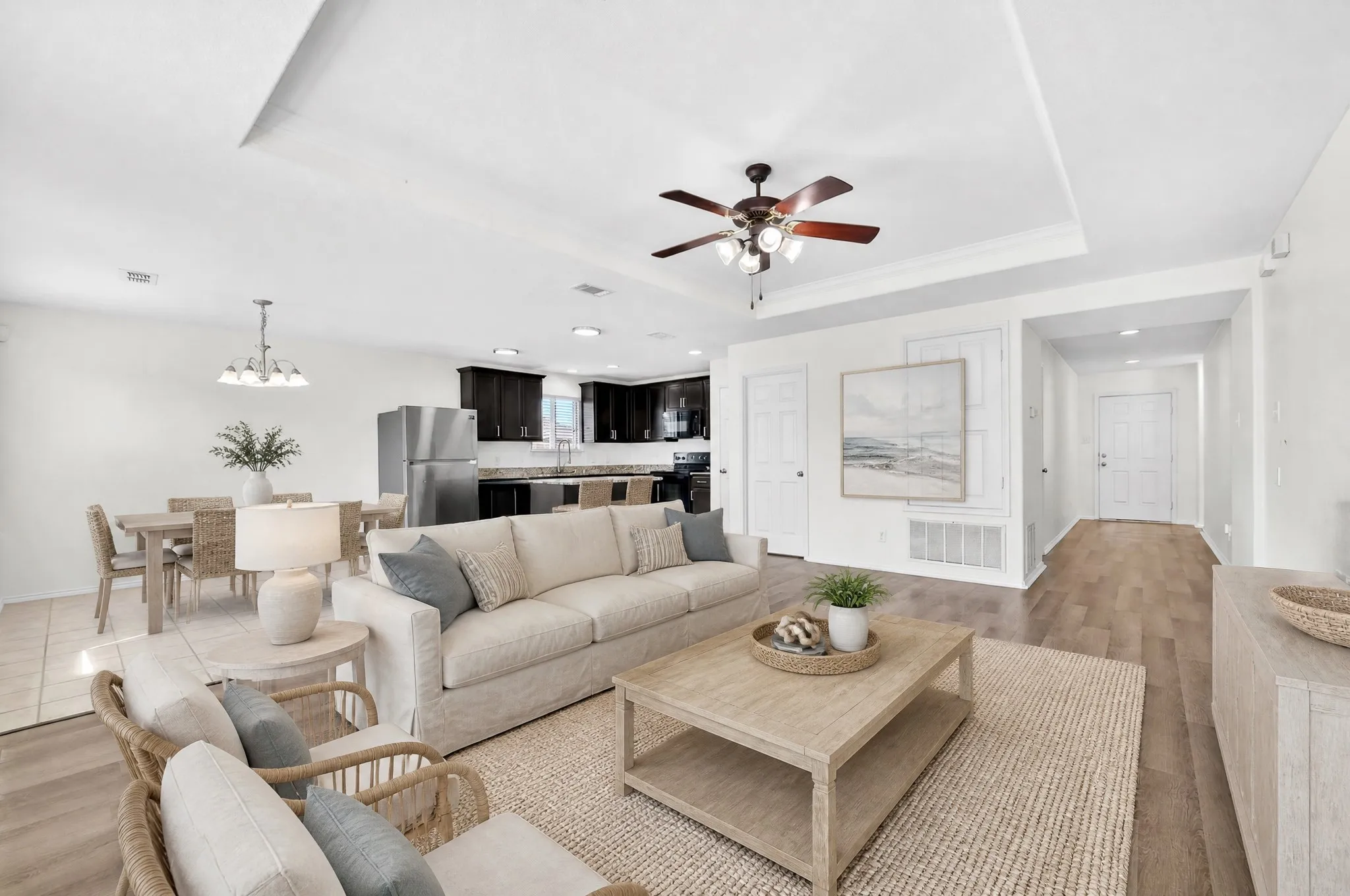 Virtually staged living room open to the kitchen