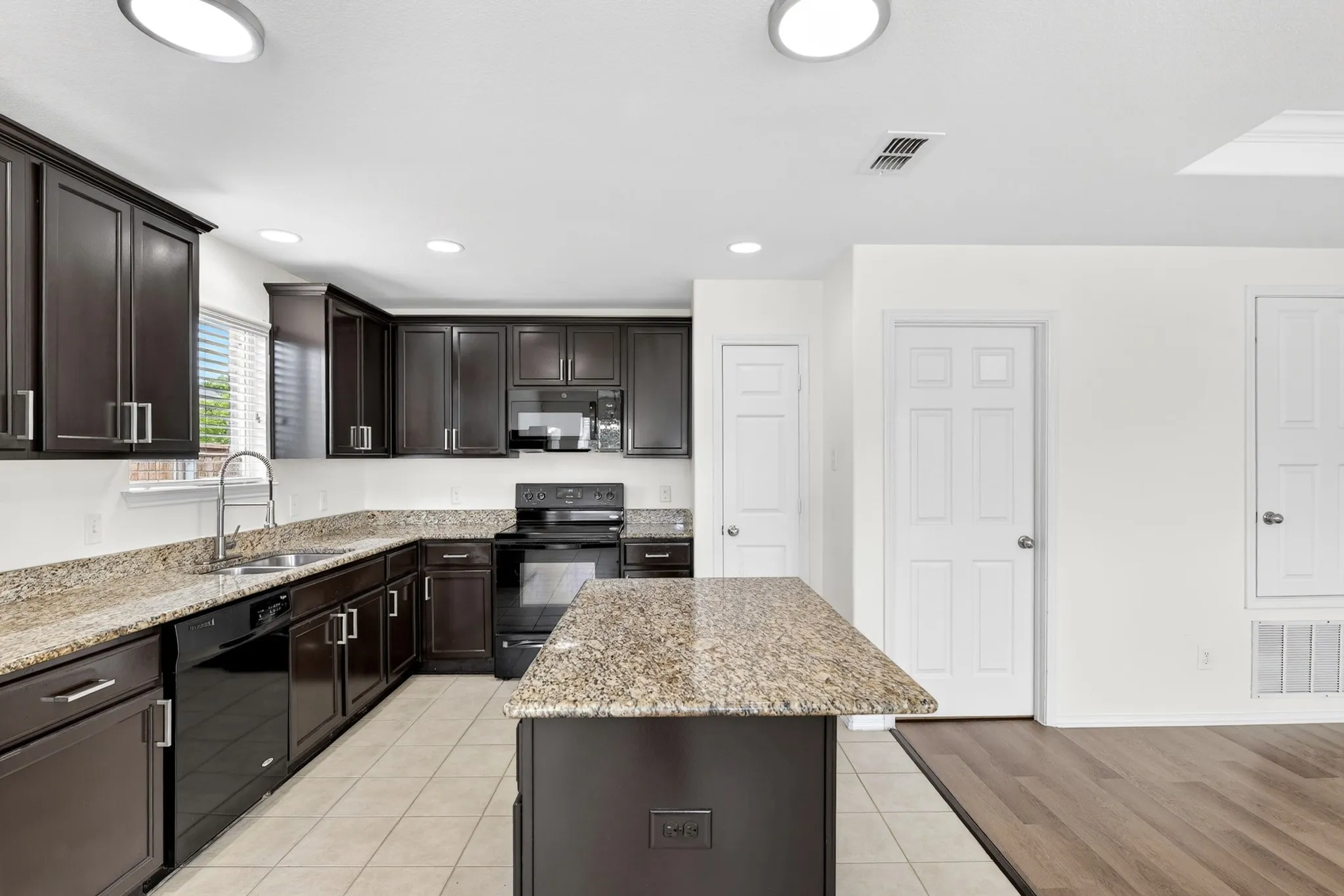 Large, Open Kitchen with granite counters and freshly painted cabinets