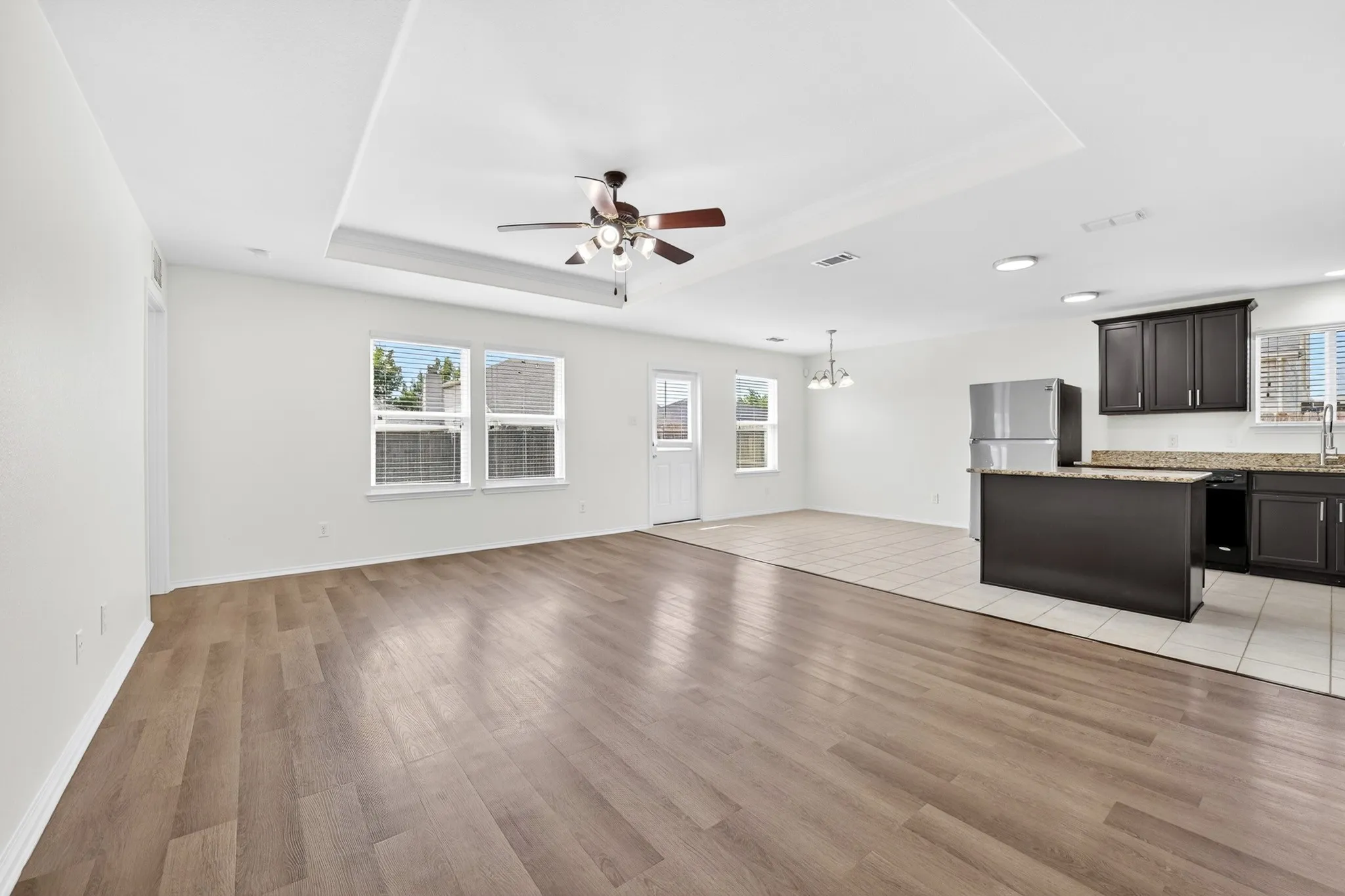 Open Floor plan with Living room open to the kitchen.  New LVP flooring and freshly painted walls and kitchen cabinets
