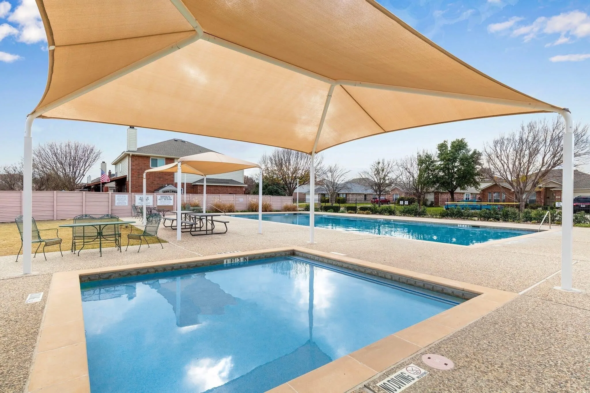 community swimming pool with patio area