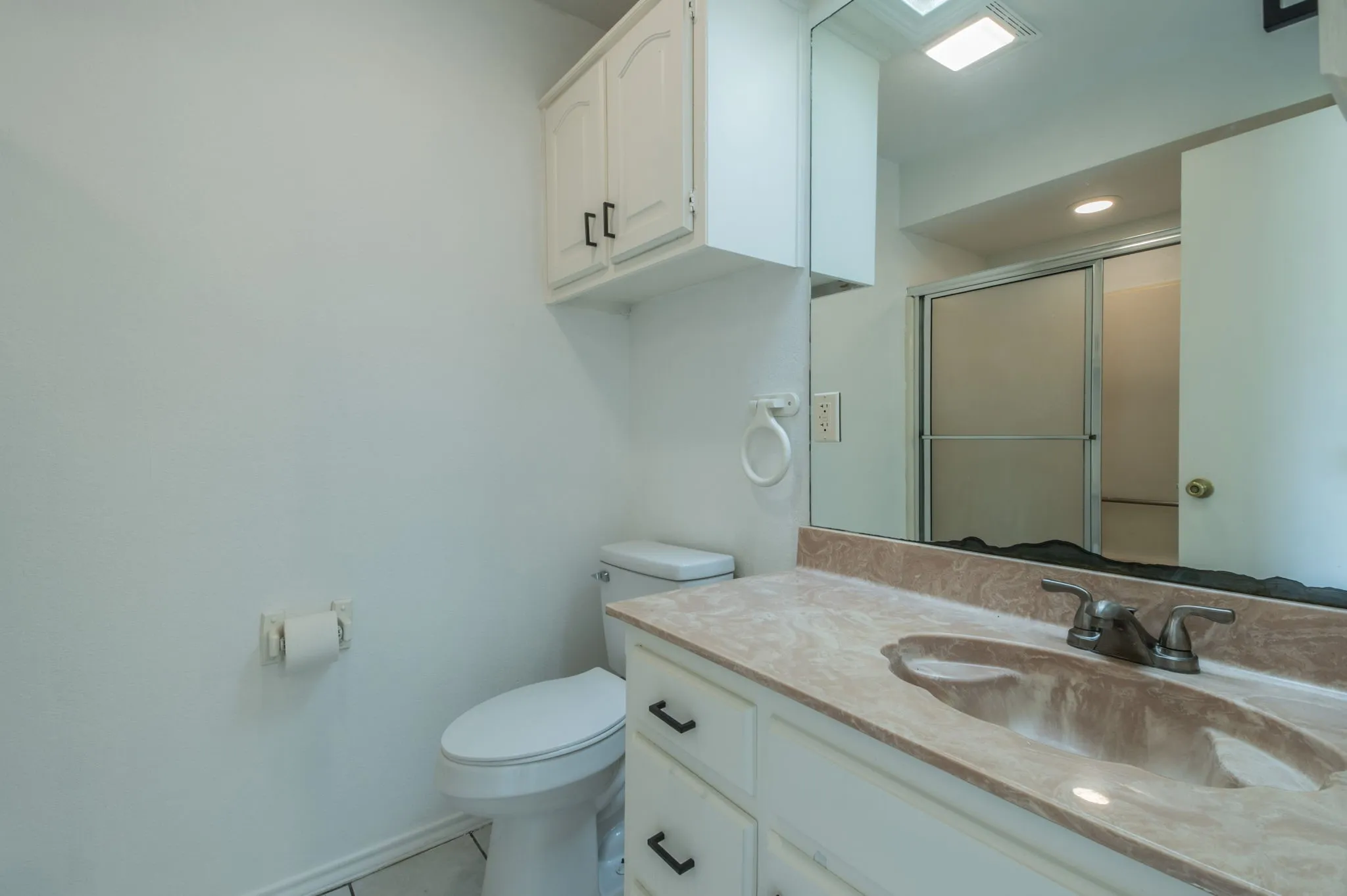 Ensuite bathroom for Guest Bedroom 1; sink and full shower/tub combo.
