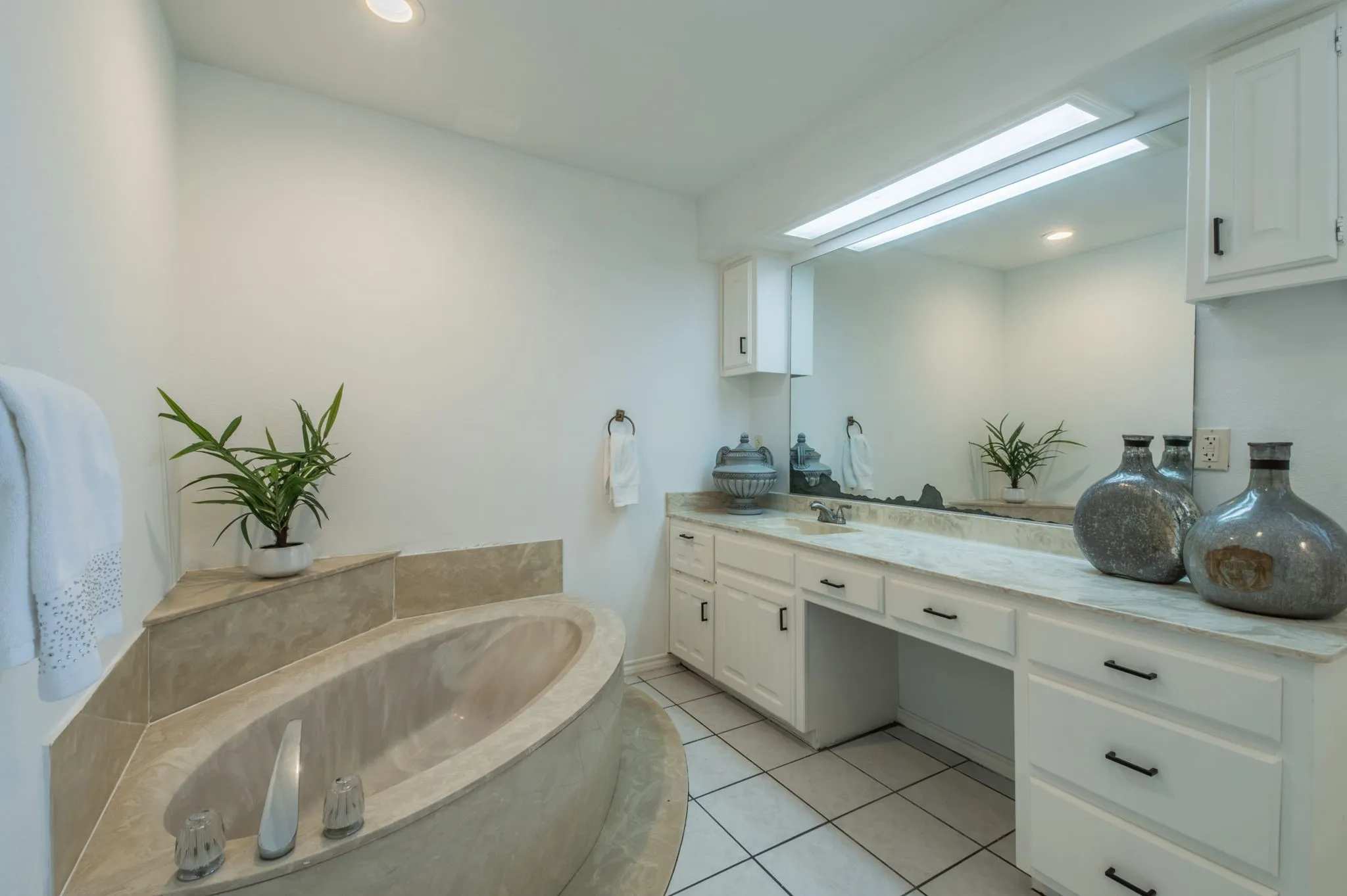 Primary bathroom with soaking tub and plenty of space for storage!
