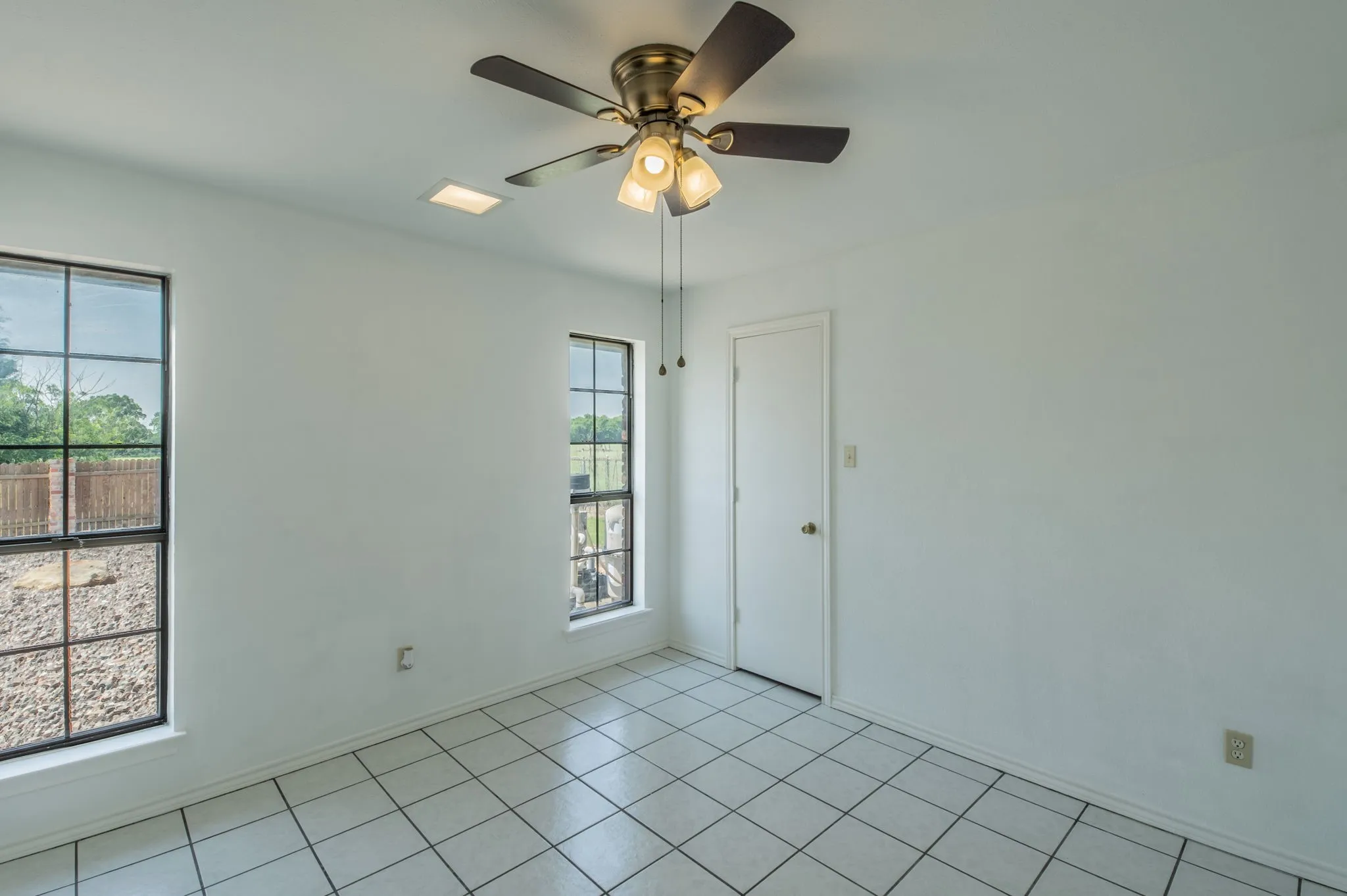 Guest Bedroom 4 with natural lighting and ceiling fan.