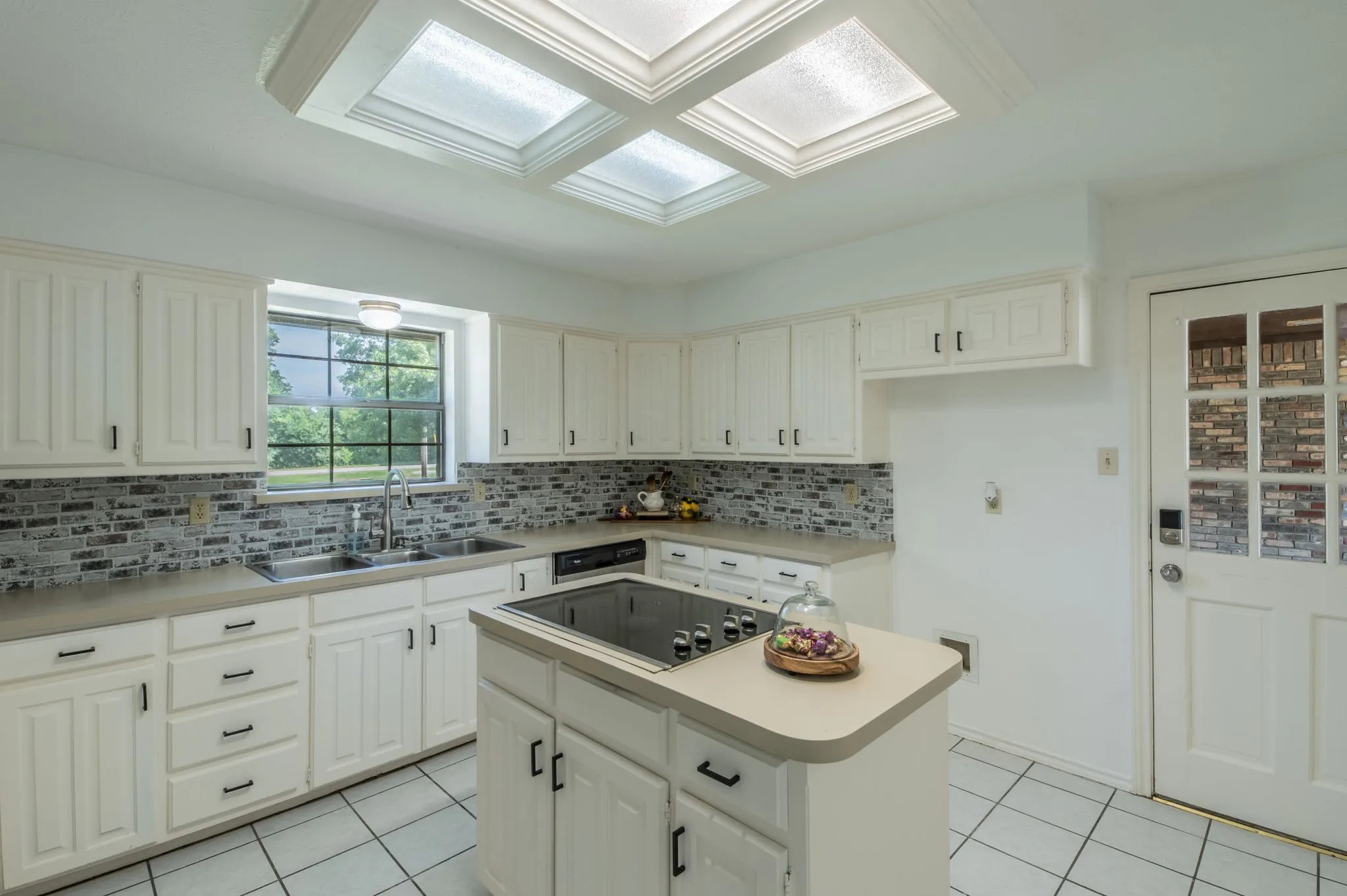 Super cute and cozy kitchen with natural light and French door leading to the porte cochère.