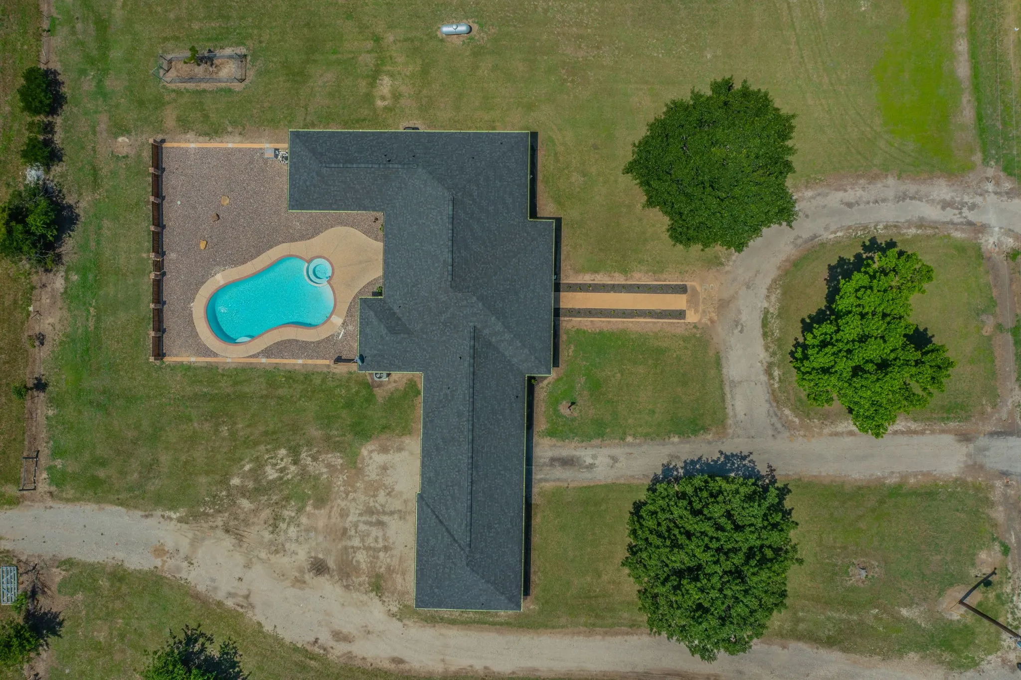 Aerial view of the house and pool, featuring mature trees!