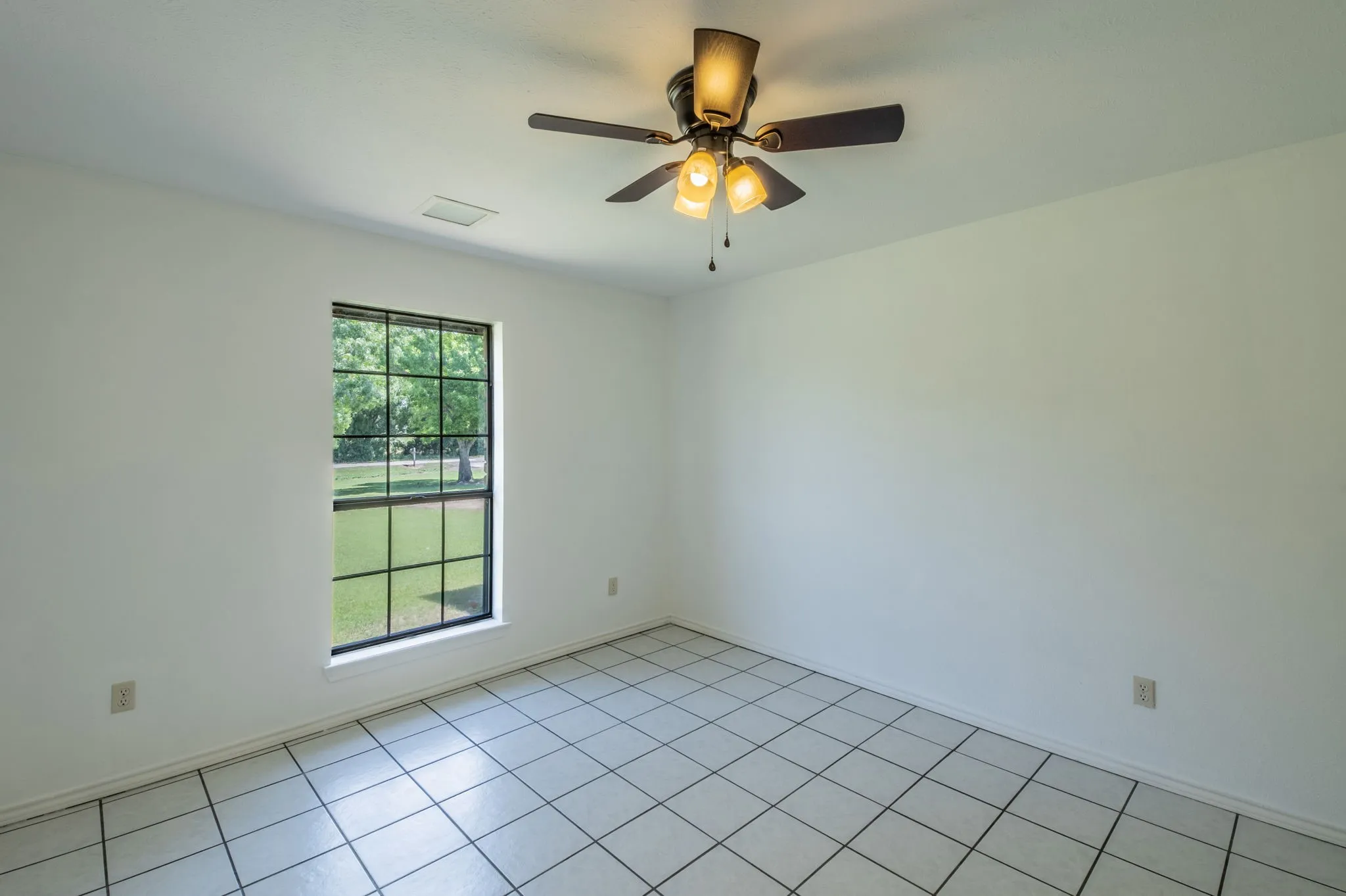 Another view of Guest Bedroom 1 featuring the window with tons of natural light.