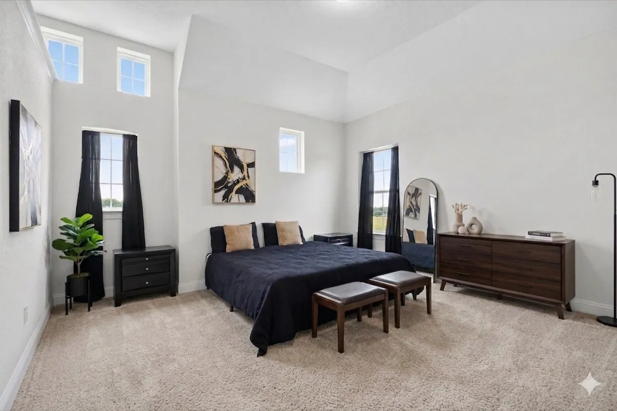 Spacious oversized room with vaulted ceilings and three large windows that fill the space with abundant natural light.
