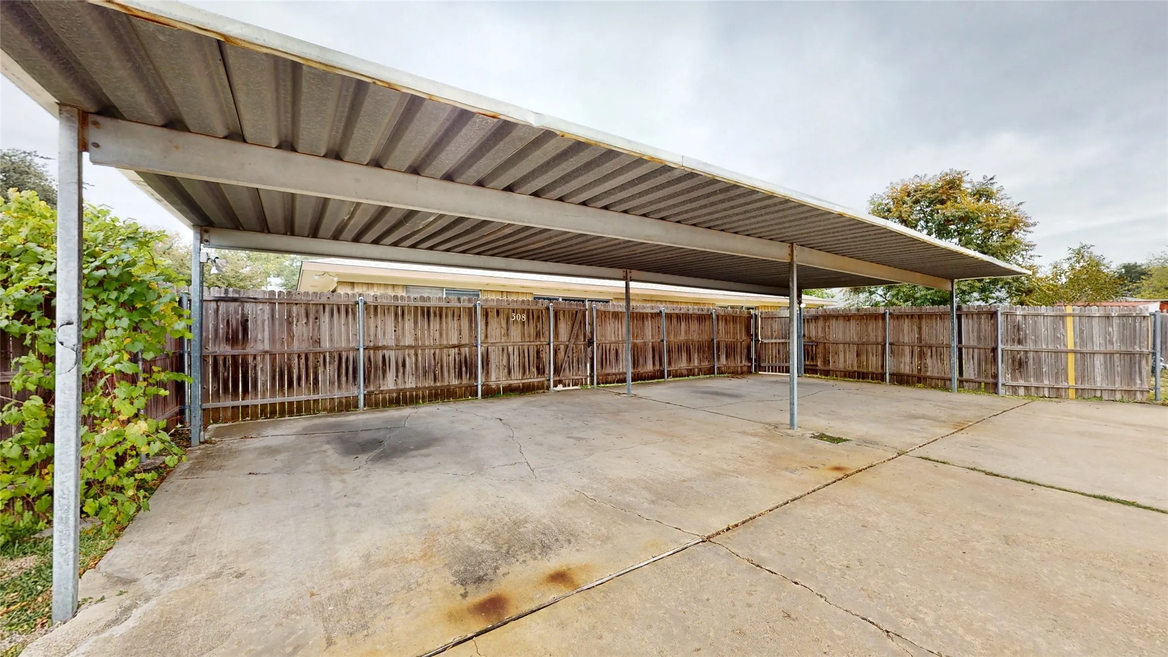 4 carport spaces in rear of unit - shared driveway. Access through each backyard